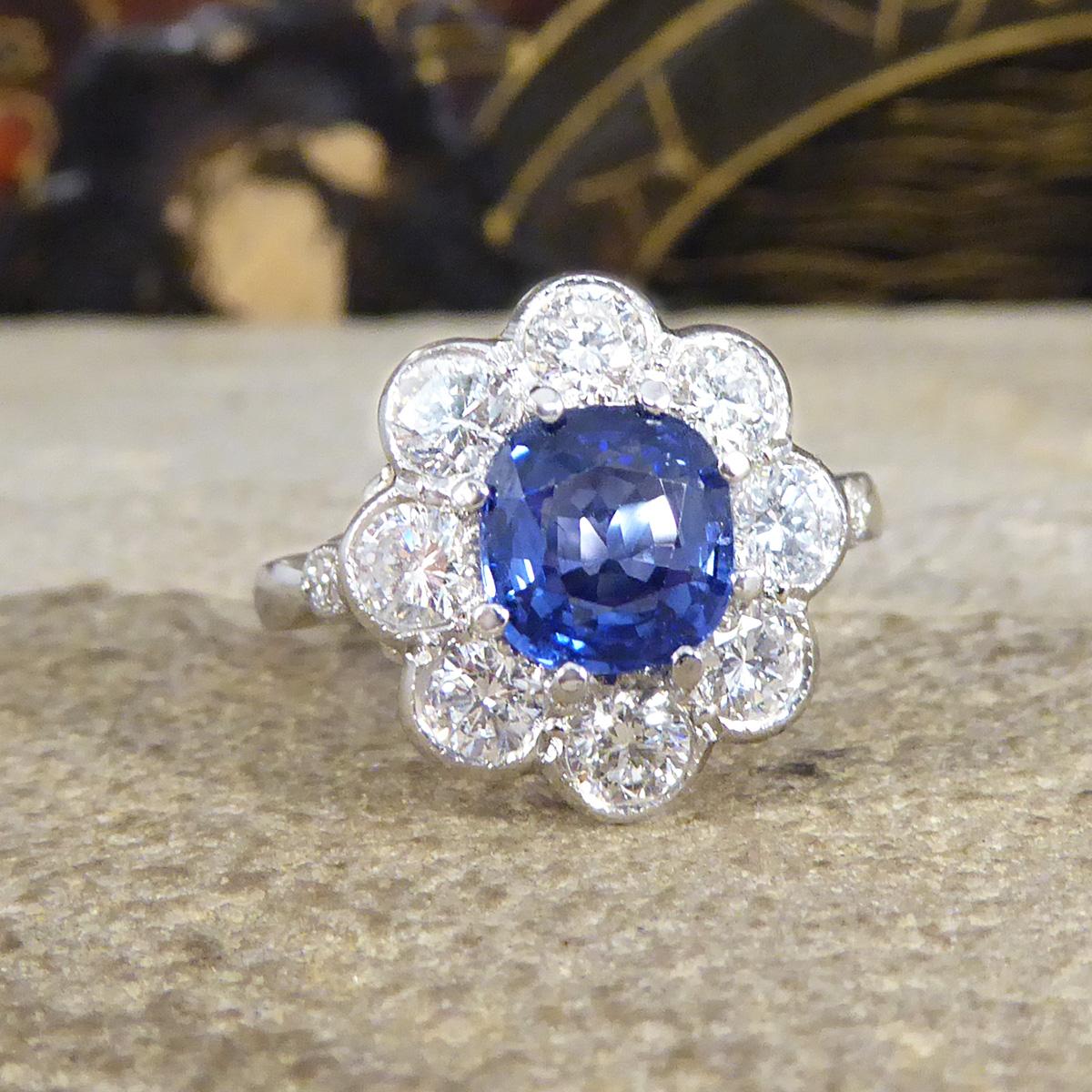 This contemporary ring has been crafted to resemble an Edwardian style ring. A 1.50ct dazzling and bright blue Sapphire in the centre of the ring and surrounded by a halo of 8 Round Brilliant Cut Diamonds weighing a total of 1.10ct giving it a