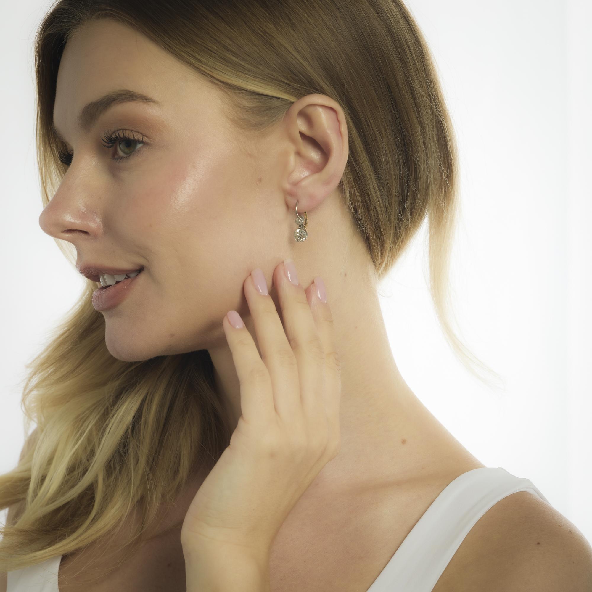 These vintage Edwardian-style earrings feature 2.30 carats of old mine cut diamonds accented by old European cuts in a graceful platinum and gold design.