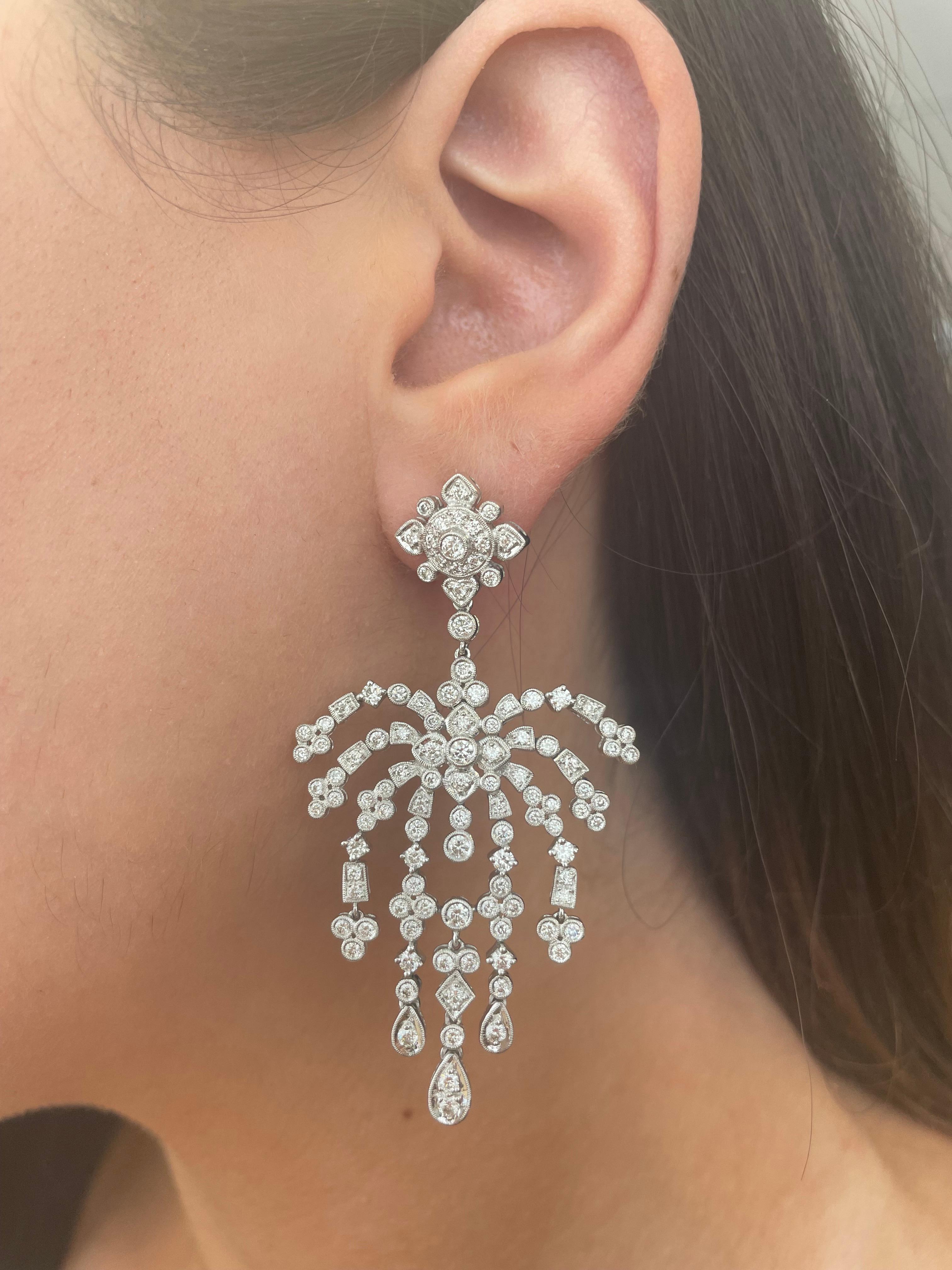 Stunning Edwardian inspired bezel set chandelier earrings.
222 round brilliant diamonds, 3.66 carats total. Approximately G/H color grade and SI clarity grade. Bezel set with milgrain work, 18k white gold.
Accommodated with an up to date appraisal