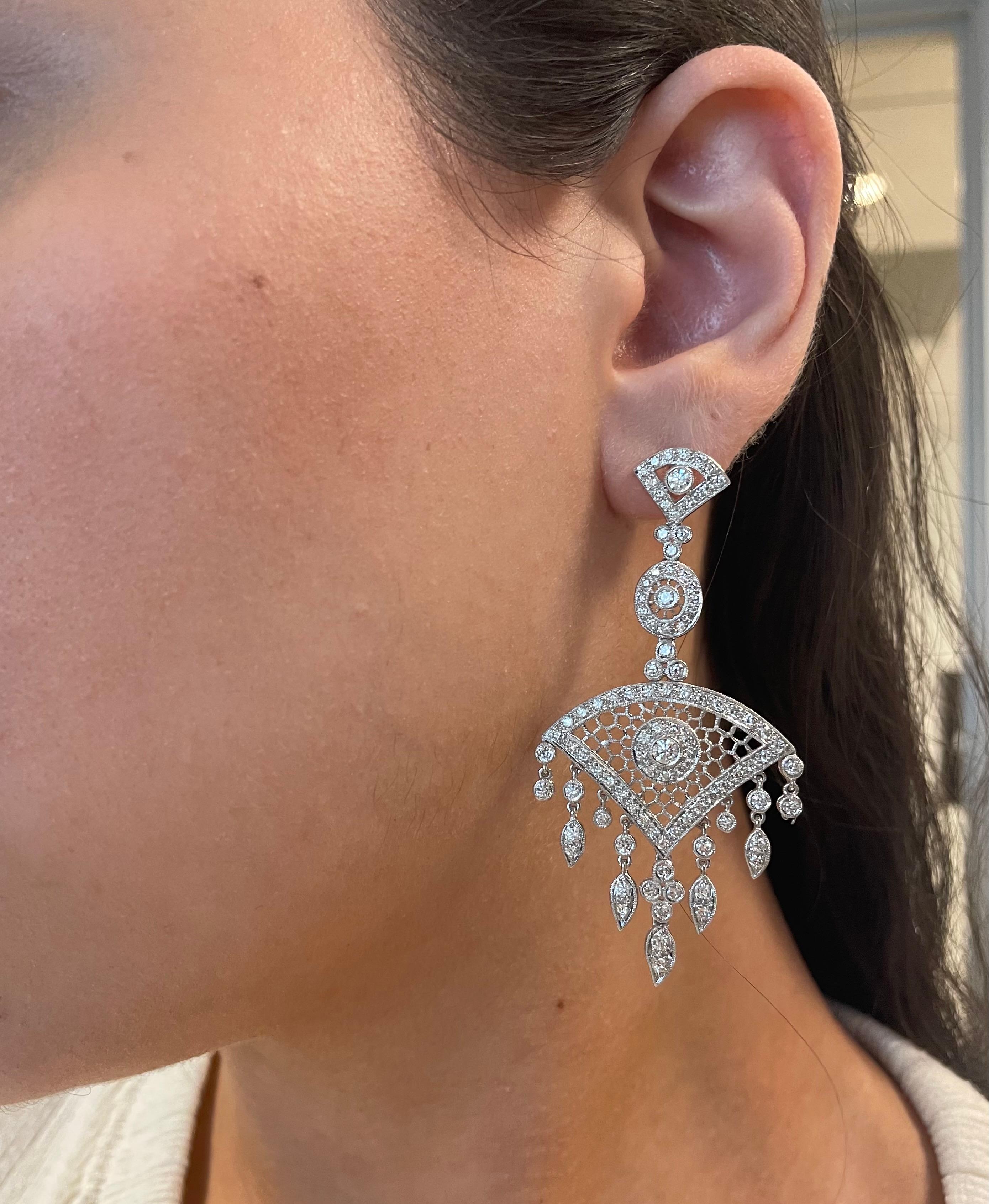 Stunning Edwardian inspired bezel set chandelier earrings.
200 round brilliant diamonds, 3.92 carats total. Approximately G/H color grade and SI clarity grade. Bezel and prong set with milgrain work, 18k white gold.
Accommodated with an up to date