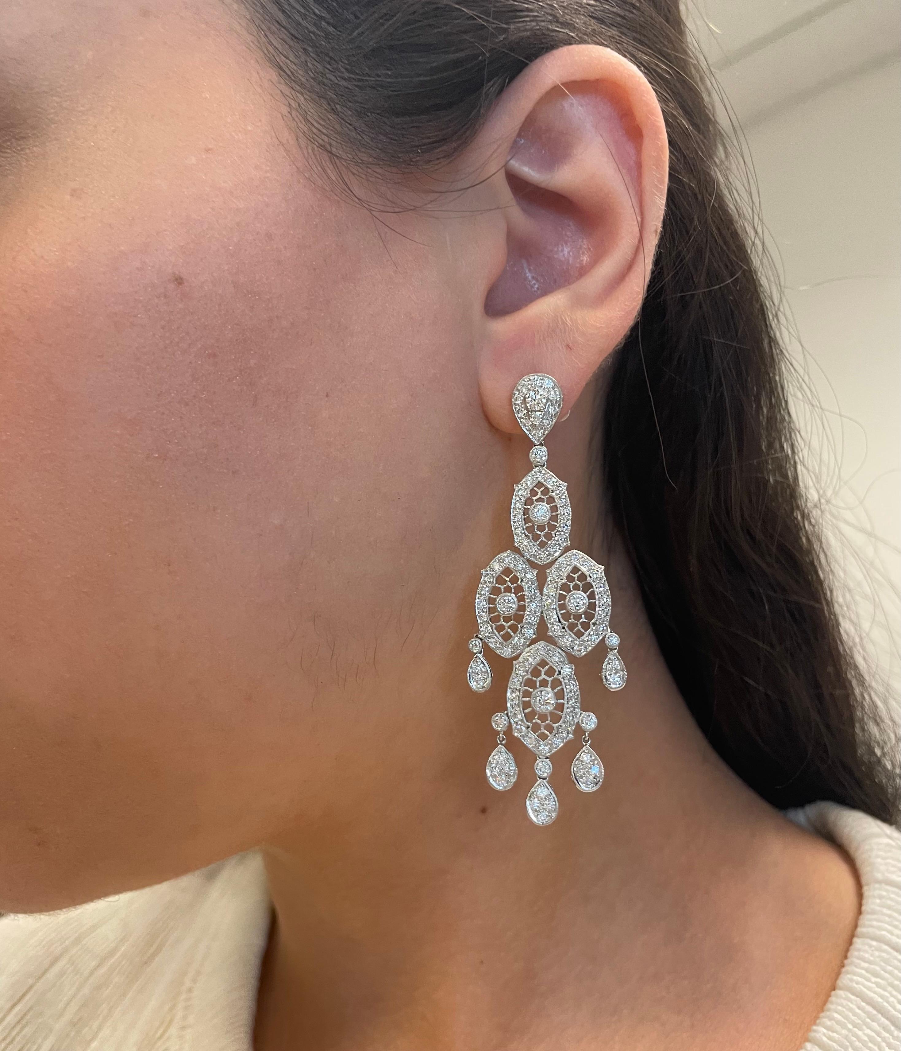 Stunning Edwardian inspired bezel set chandelier earrings.
204 round brilliant diamonds, 4.01 carats total. Approximately G/H color grade and SI clarity grade. Bezel and prong set with milgrain work, 18k white gold.
Accommodated with an up to date