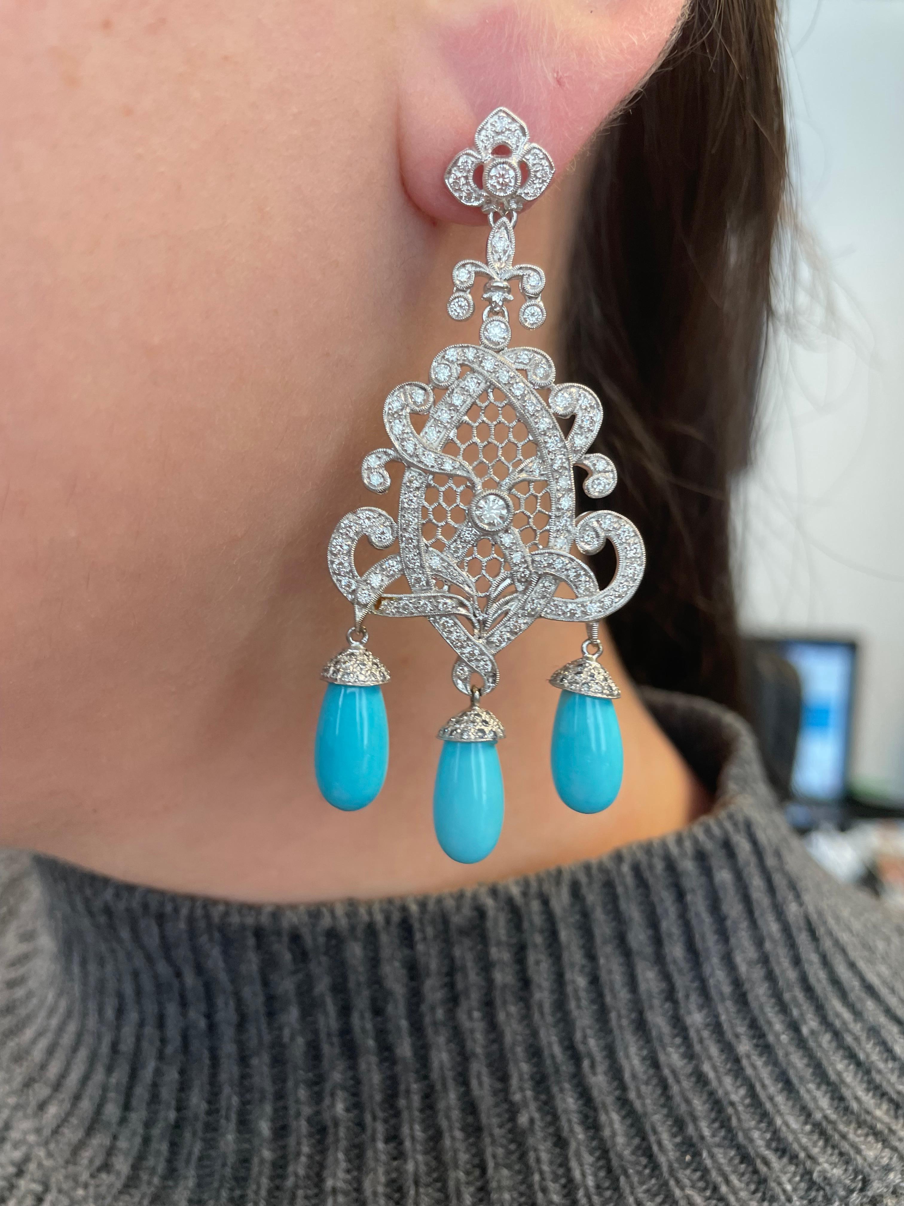 Edwardian inspired turquoise and diamond earrings.
4.45 carats of round cut diamonds, approximately H/I color and SI clarity. Complimented with 6 turquoise, 18-karat white gold.
Accommodated with an up to date appraisal by a GIA G.G. upon request.