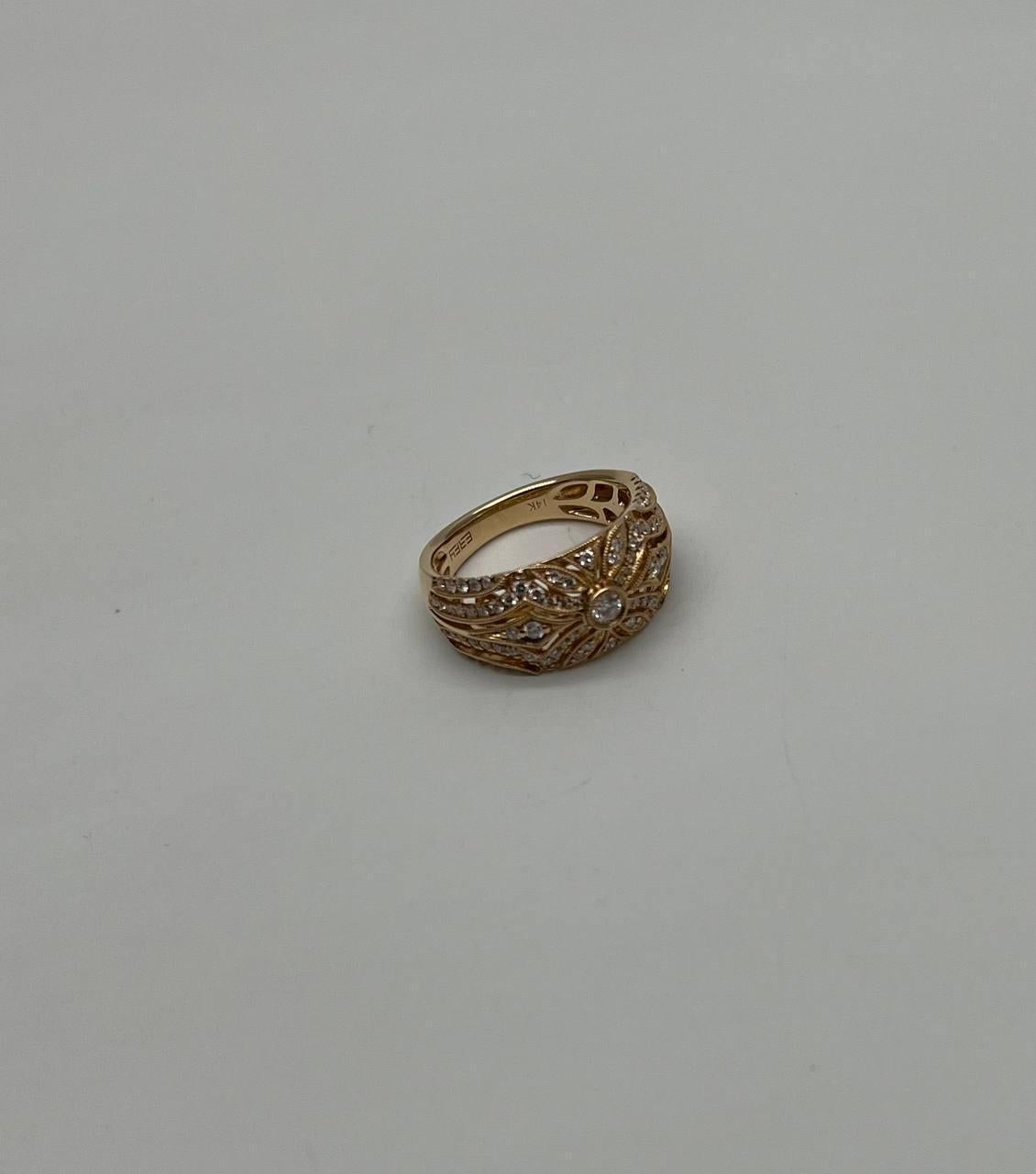 This captivating piece, made from 14K yellow gold, features a central design adorned with 0.57 carats of white diamonds. The intricate pattern showcases a harmonious blend of delicate curves and sparkling accents, creating a timeless and