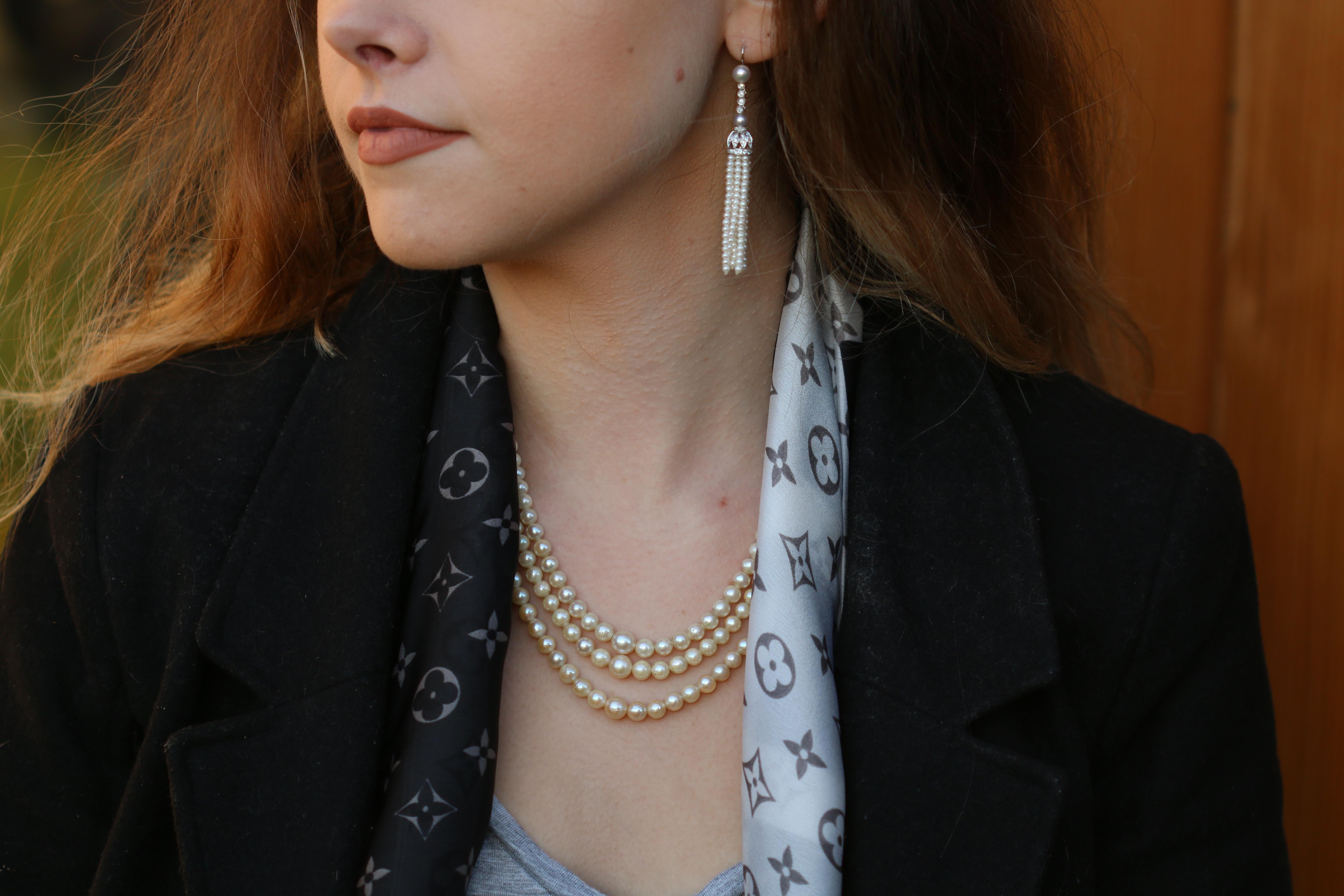These eye-catching Edwardian style diamond and pearl tassel earrings bring such a classic and elegant style. As Jackie Kennedy said 'Pearls are always appropriate'.

Made from 18K white gold, beginning with a single pearl measuring roughly 5.9mm,