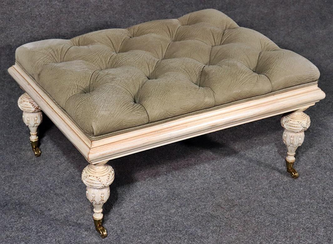 Edwardian style distressed painted ottoman with tufted upholstery on casters.