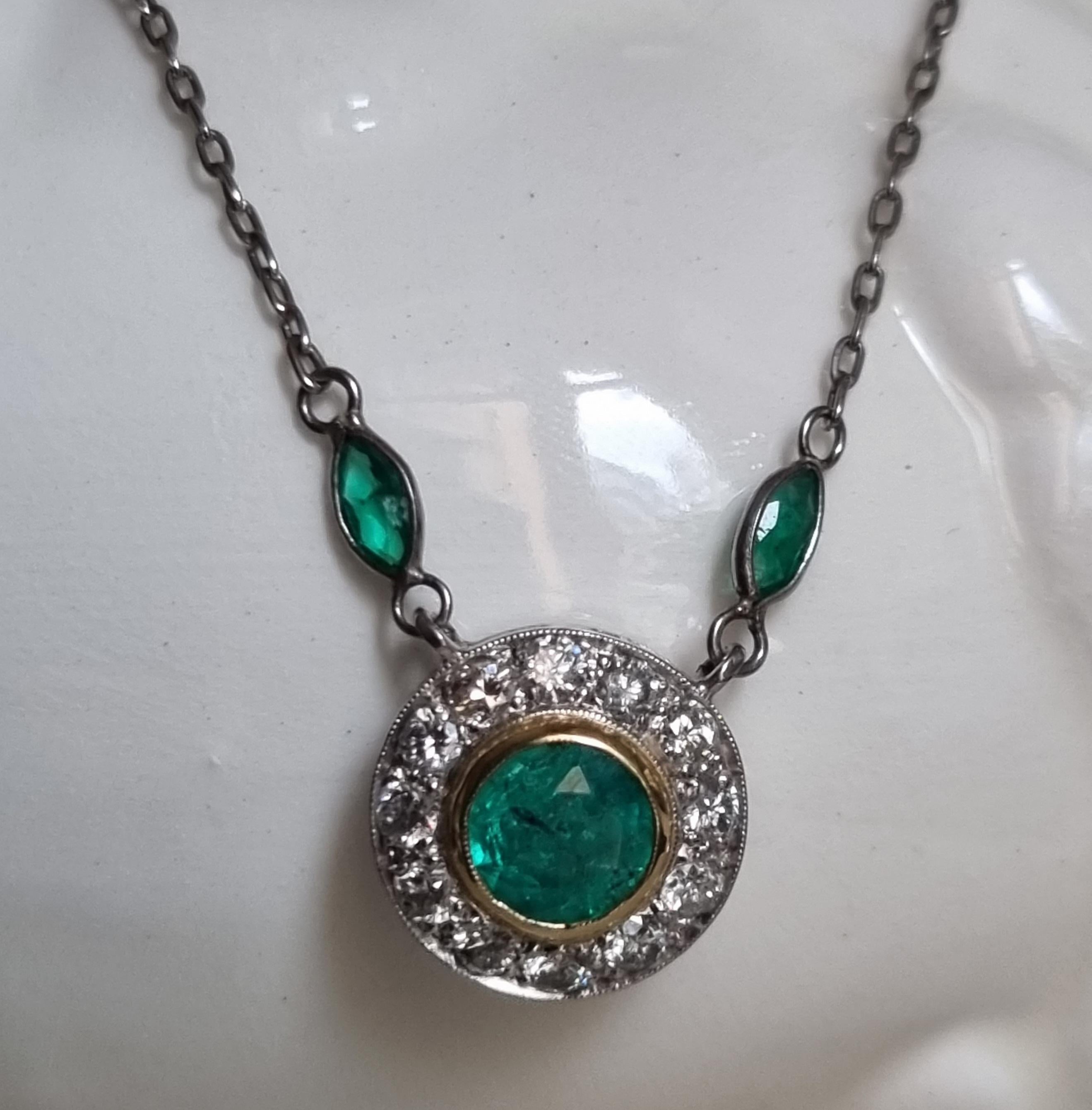 Edwardian Style  Emerald  and Diamond  Pendant & Chain.
A bright neon green and lovely .85 carat emerald (7mmX3.65mm), set in a yellow gold bezel and surrounded by a round frame of Swiss-cut 12 diamonds. Total diamond weight - .60 carat (color I/J;