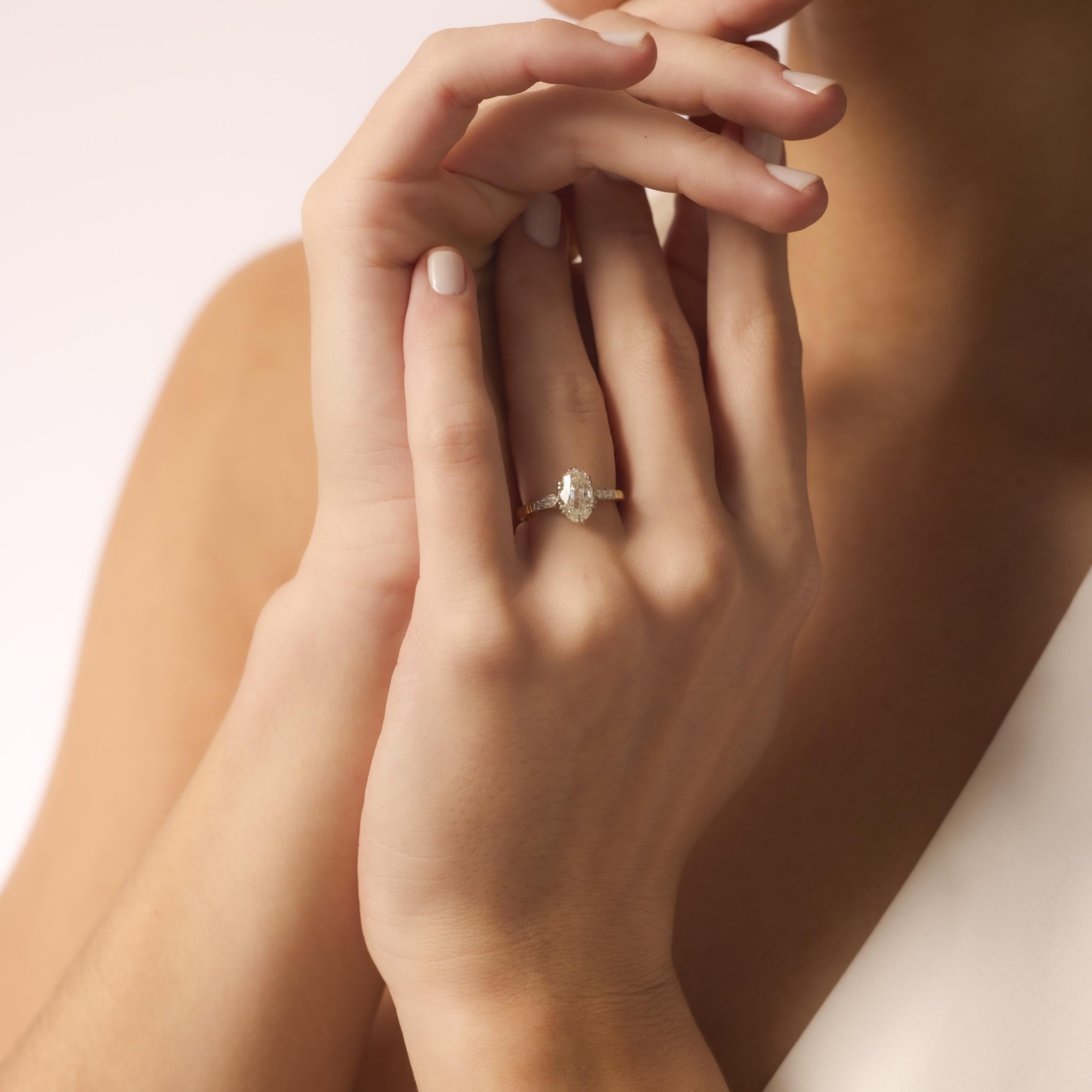 This Edwardian-style ring showcases a 1.80 carat old mine cut diamond in a platinum and gold setting with sparkling brilliant diamond accents.