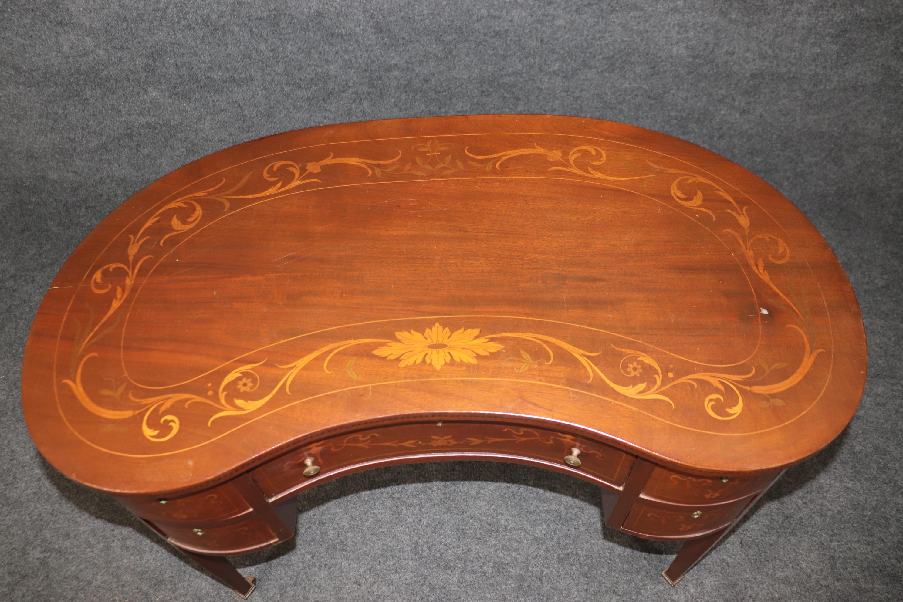 This is a diamond in the rough. This is a superb smaller scale Edwardian English desk that has intricate satinwood inlay and gorgeous design and proportions. The condition is a little rough and needs some TLC to bring it back to its best. Dates to