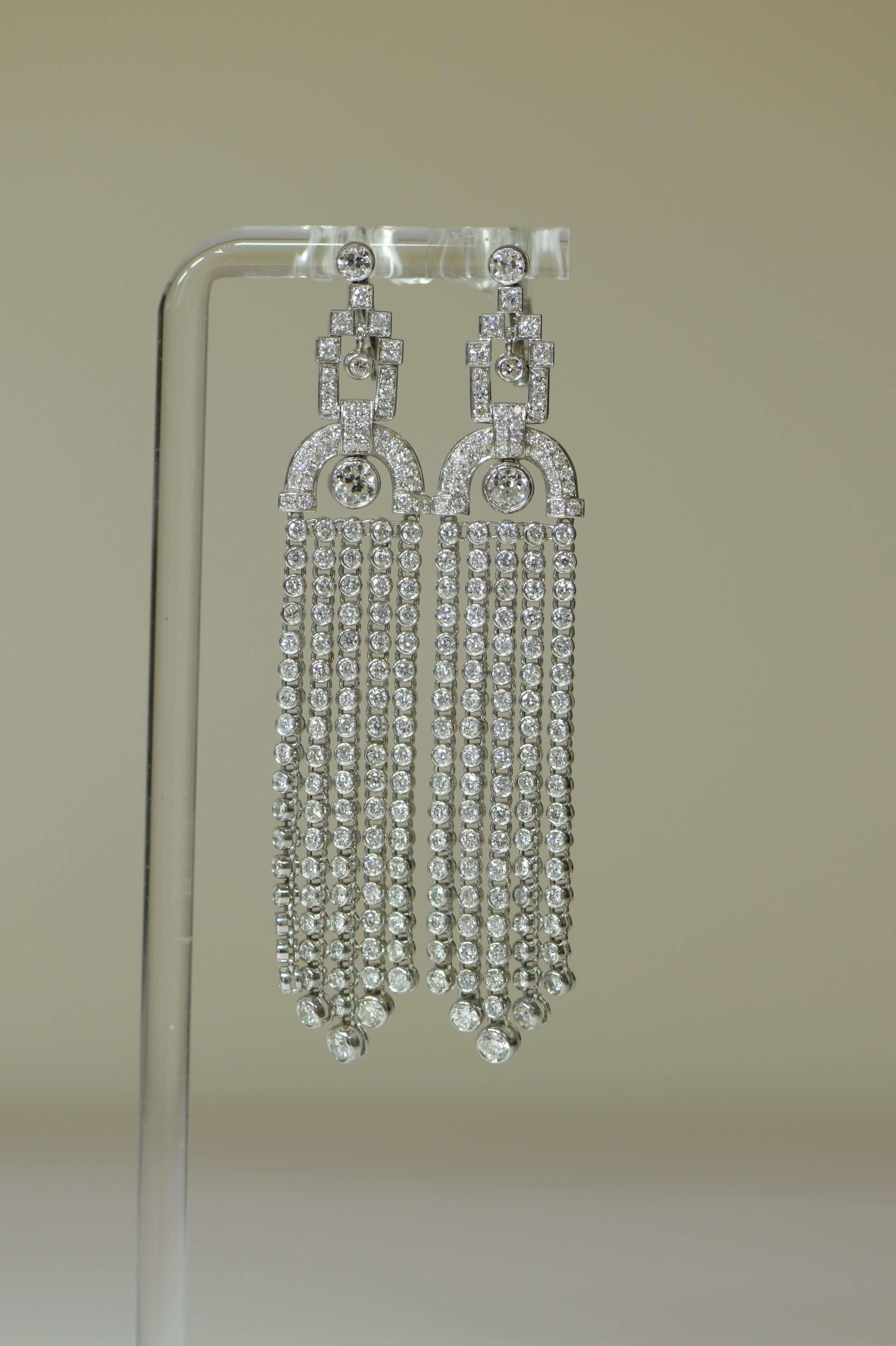 A wonderfully elegant pair of long earrings. Hanging below the top part are four tassels with such flexibility. They hang straight when not moving but as soon as there is a touch or any movement they shimmer and catch the light. 

The craftsmanship