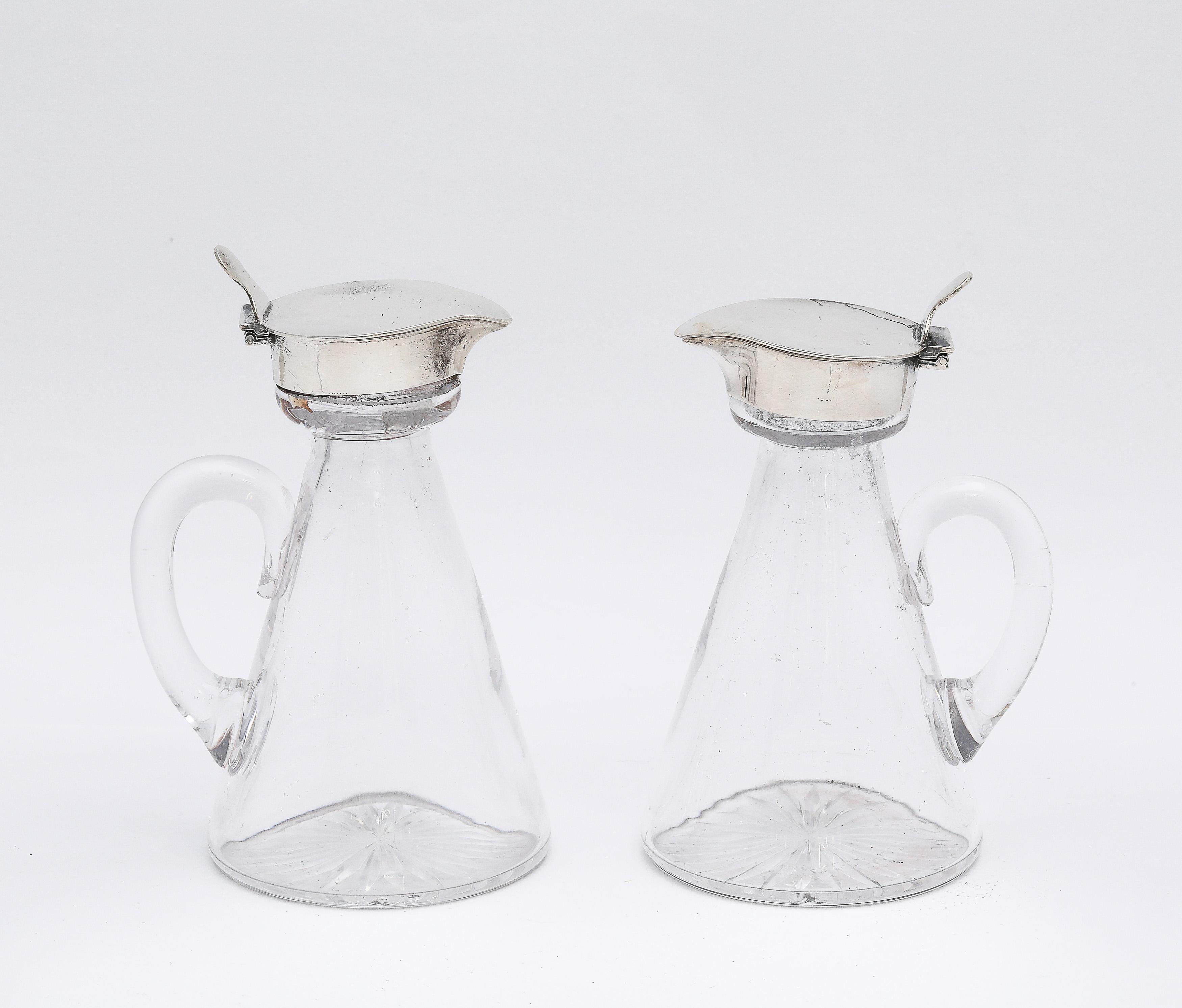 Edwardian Style, sterling silver-mounted hand-blown glass whiskey tots/noggins, American, Ca. 1930's. Each tot/noggin has an incised star cut into the underside of its base. Each tot measures 4 inches high to highest point of hinged sterling silver