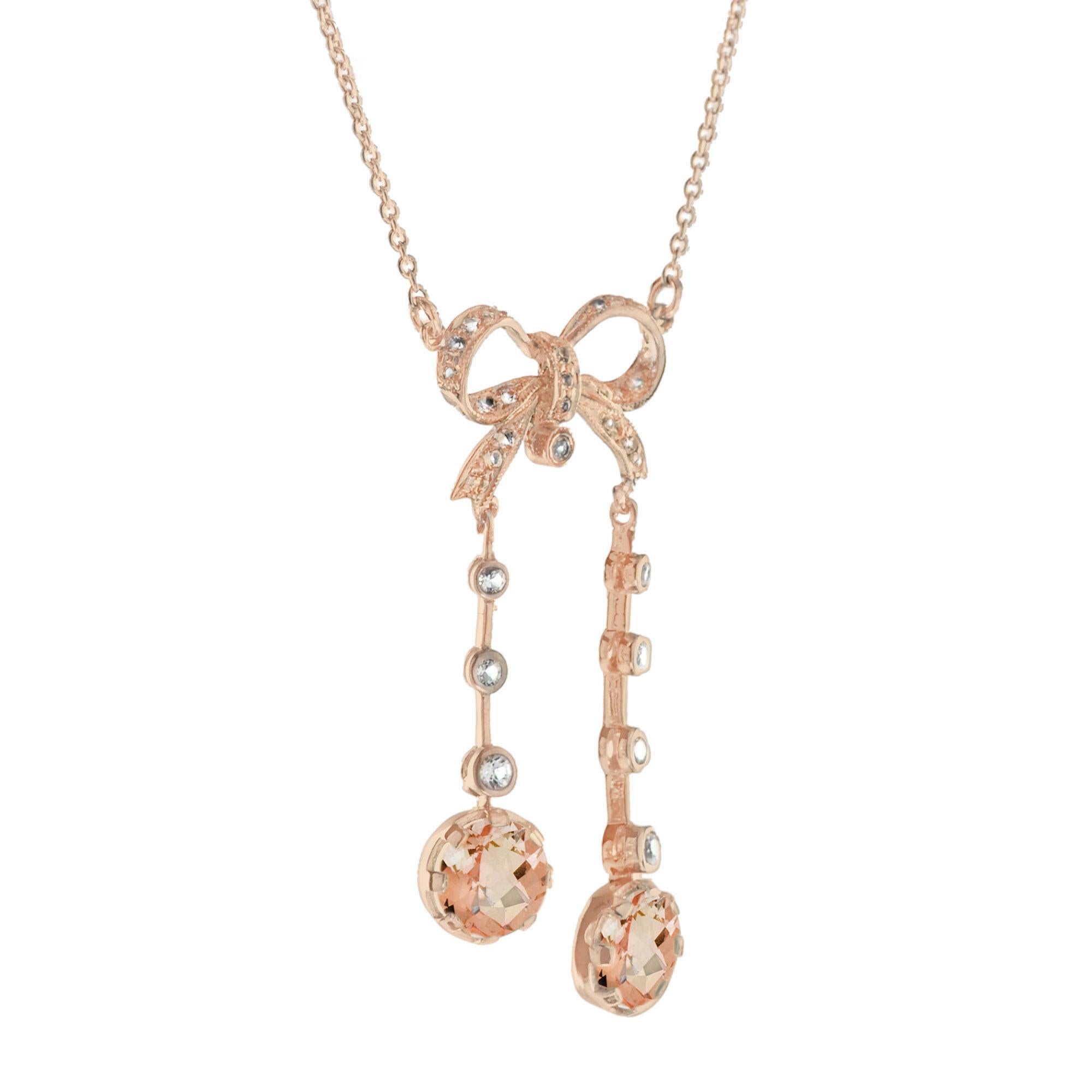 Edwardian style necklace comprised of two morganite and diamond drops suspended below a bead-set diamond ribbon bow. The necklace is a wonderful example of Edwardian-era jewelry and would make an ideal gift to the bride or someone you love. 14K Rose