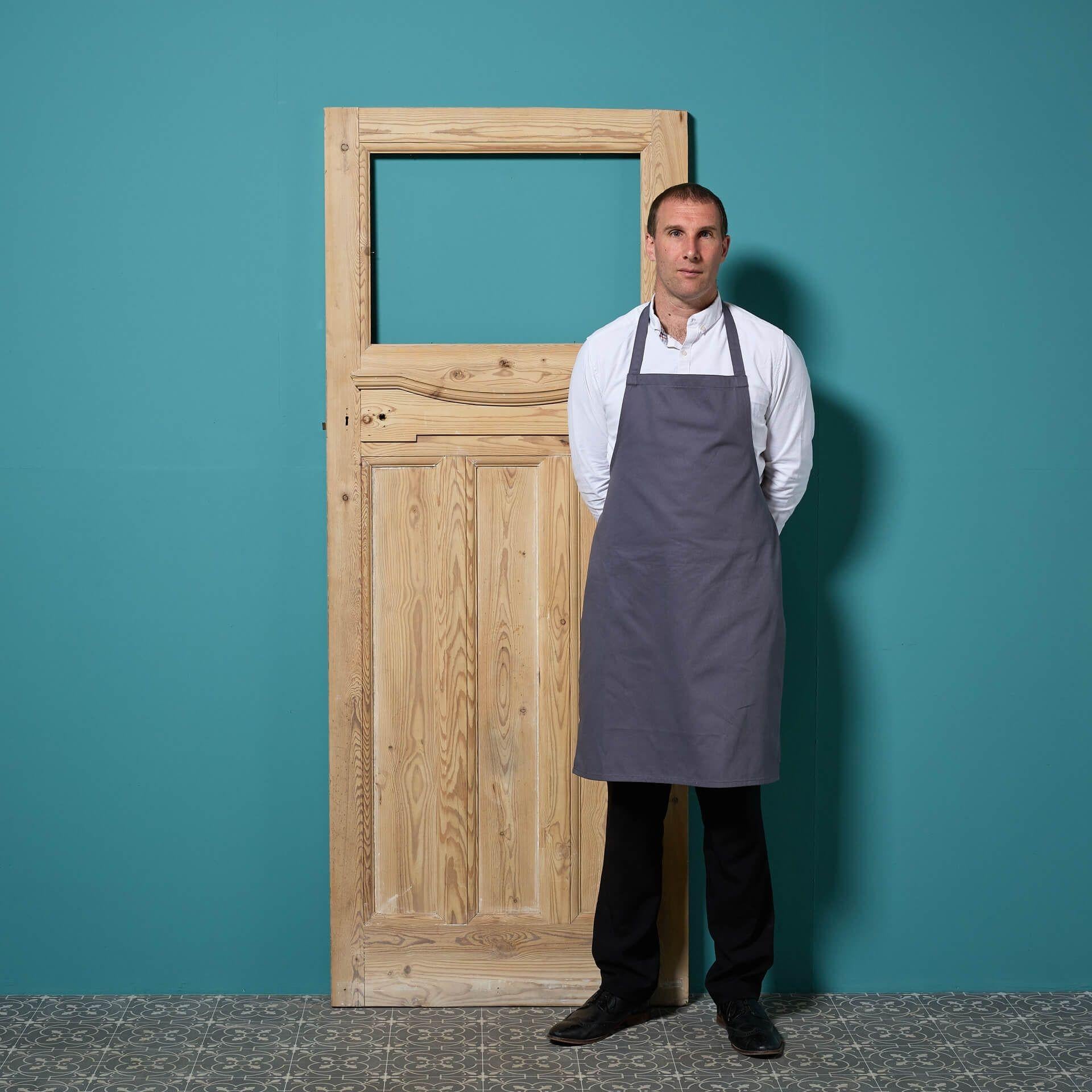 An Edwardian style reclaimed stripped pine door, ready for glazing.

The door has three narrow vertical panels, topped with a sweeping moulding on a raised panel. The contrast of sharp lines with the mildly curved ledge allows this door to traverse