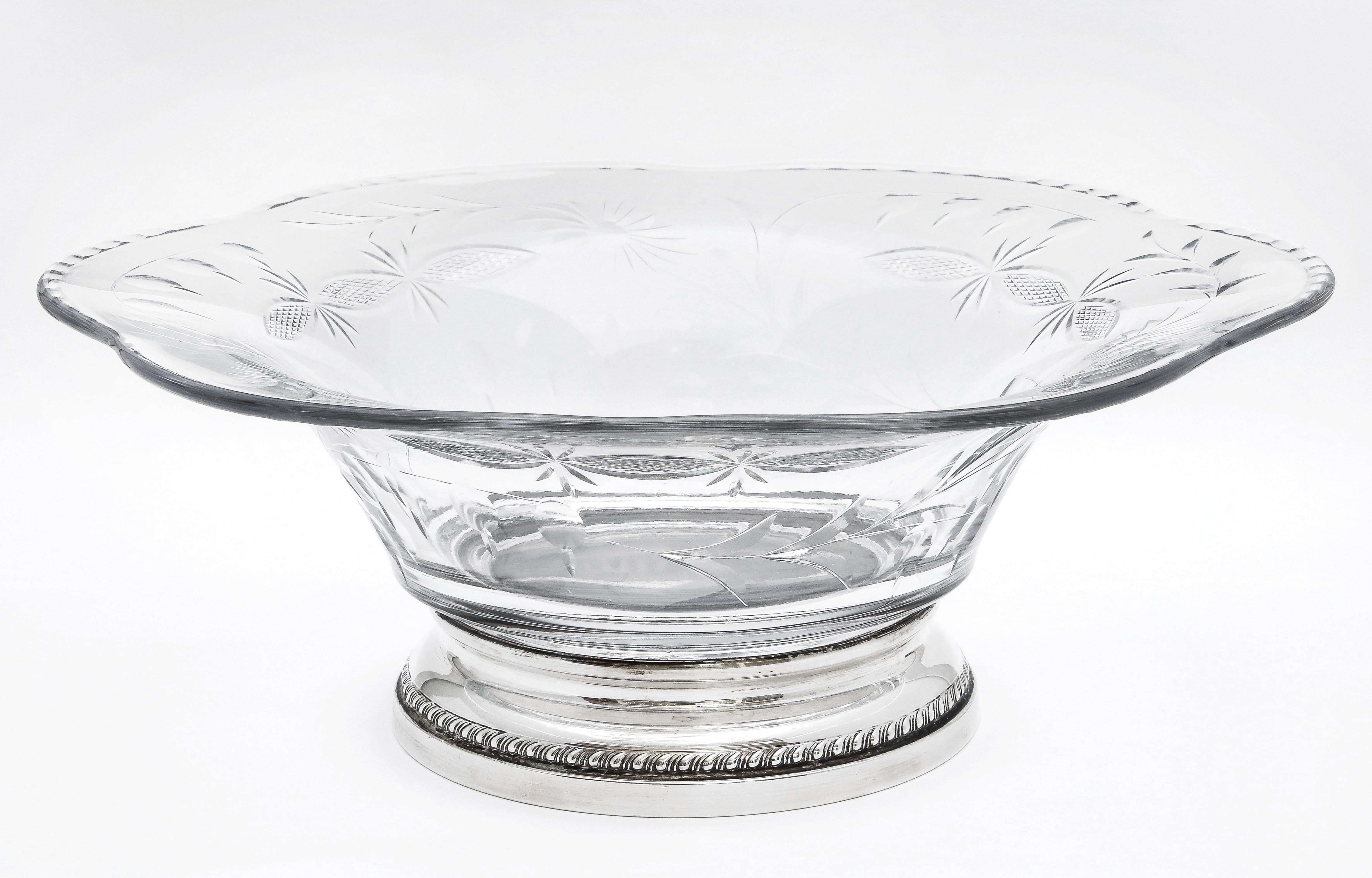 Edwardian-style, sterling silver-mounted wheel cut glass centerpiece bowl, Sheffield Silver Company, Brooklyn, New York, Ca. 1930's-1940's. Glass is beautifully wheel cut with leaves and flowers (see photos). Base is sterling silver. Measures 12 1/2