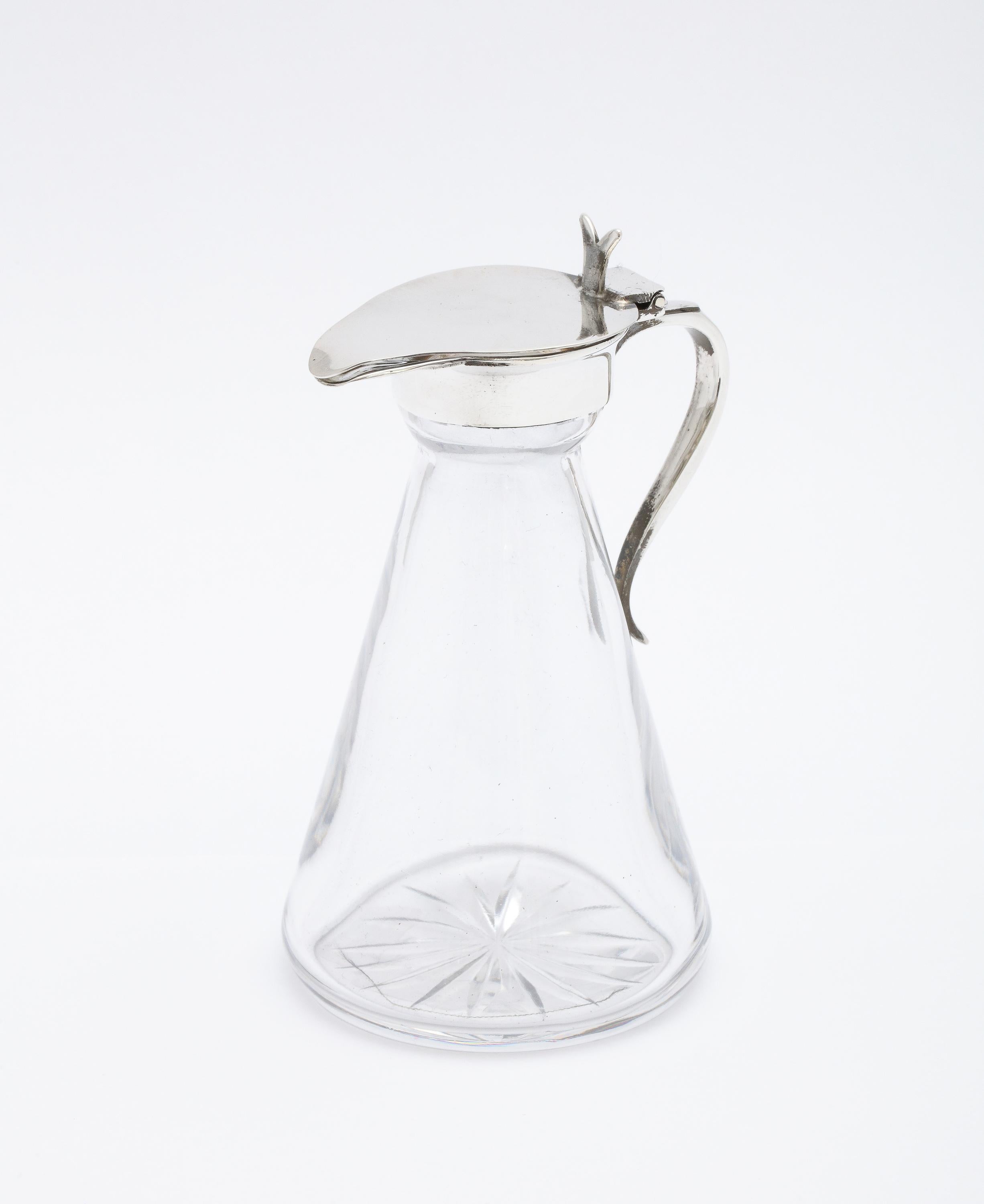 Edwardian-style, sterling silver-mounted glass whiskey tot, Birmingham, England, year-hallmarked for 1959, Barker Bros. Silver, Ltd.- makers. Graceful design, having an incised starburst pattern on its underside. Handle is also sterling silver.