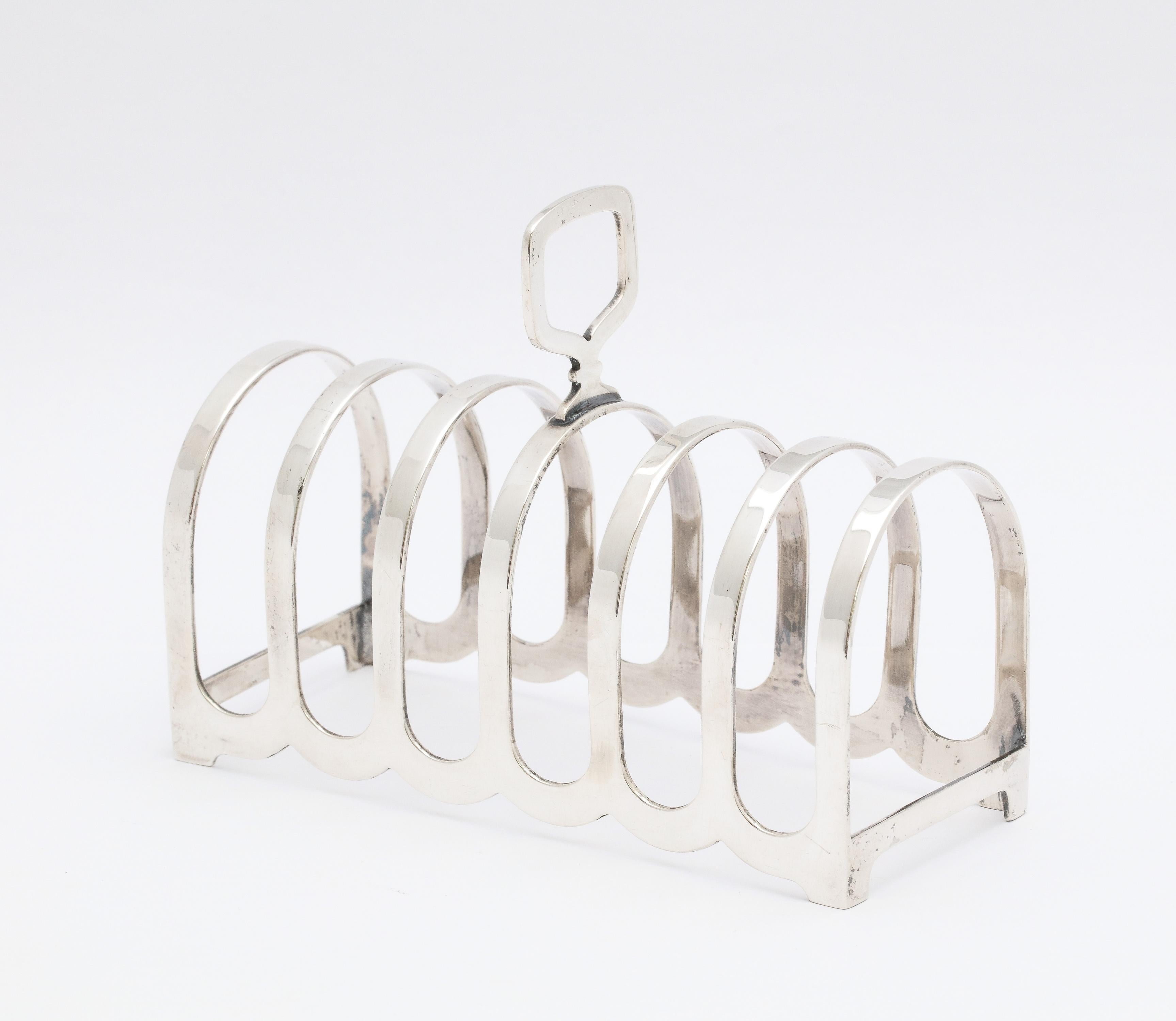Edwardian Style, sterling silver toast rack, Birmingham, England, year-hallmarked for 1959, Suckling, Ltd. - makers. Measures 4 1/2 inches long x 3 1/2 inches high (to top of finial) x 2 inches deep. Will hold 6 slices of toast. Weighs 2.485 troy