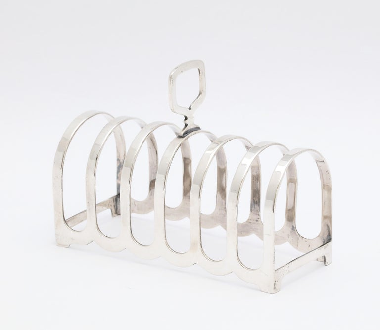 Edwardian Style, sterling silver toast rack, Birmingham, England, year-hallmarked for 1959, Suckling, Ltd. - makers. Measures 4 1/4 inches long x 3 3/4 inches high (to top of finial) x 2 inches deep. Will hold 6 slices of toast. Weighs 2.485 troy