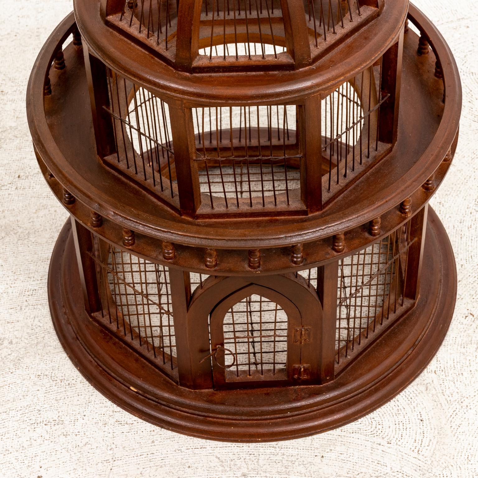 Circa early 20th century Edwardian style wood and wire birdcage in the form of a cupola with Gothic arch style front door and blustered gallery surround. Please note of wear consistent with age including slight wear consistent with age and use.