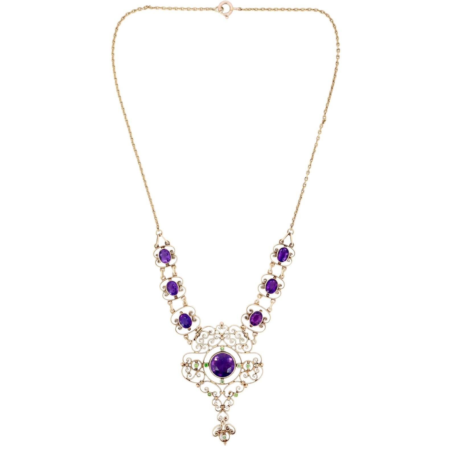 An Edwardian period amethyst, and demantoid garnet lavalier necklace in 15 karat gold. Crafted in England at the turn of the 20th century, this beautiful piece of jewelry also holds an important meaning. Used together, the colors of the purple