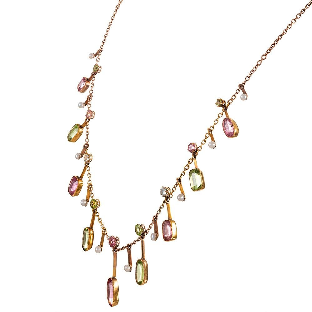 Pink tourmaline, peridot, pearl and aquamarine… this color combination of gemstones was likely. Assembled as a nod to the women’s suffrage movement, so a lady could subtly show her support. 
In 1908 the co-editor of the WSPU's newspaper 