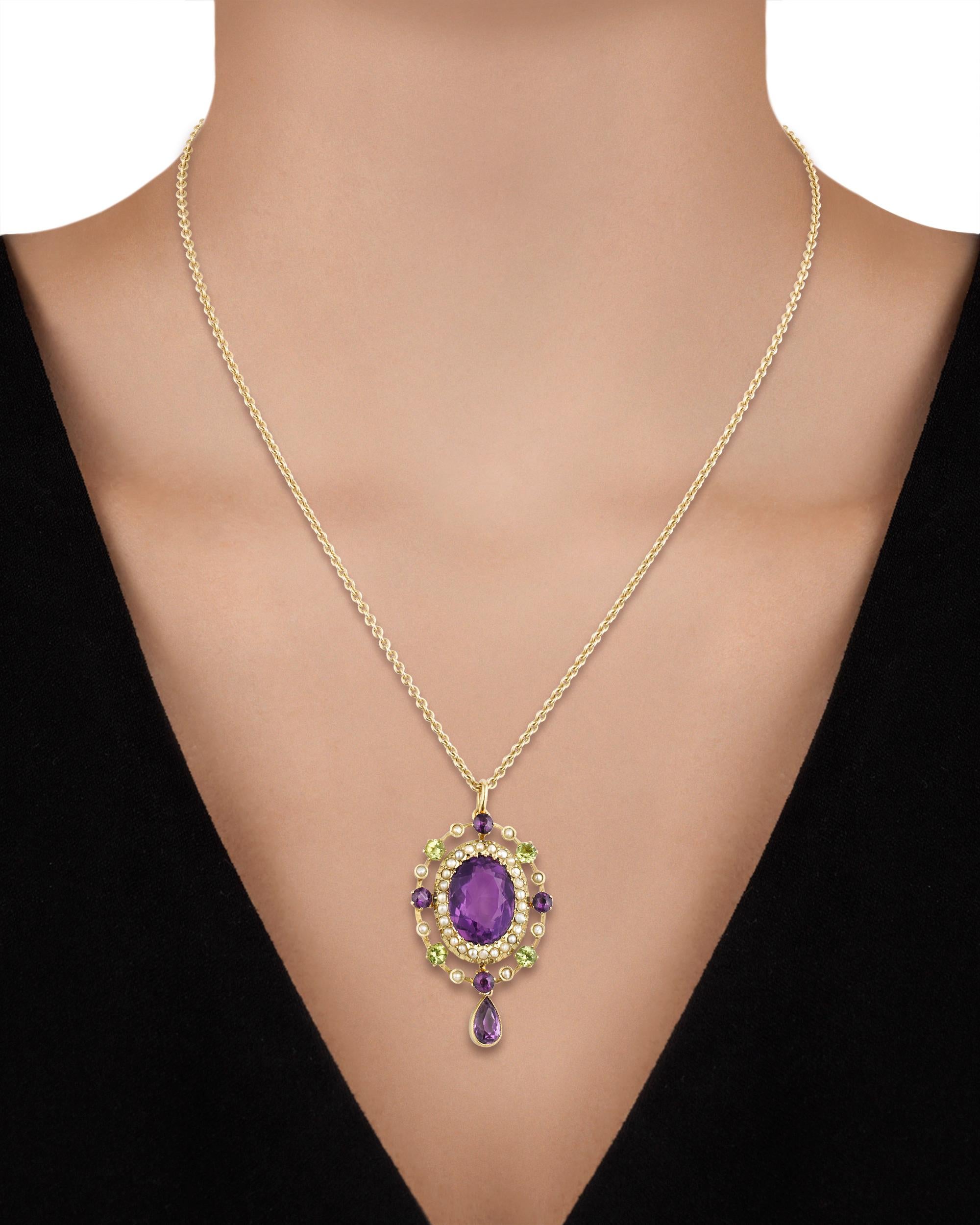 A dazzling piece of history, this rare Edwardian pendant is a stunning example of suffragette jewelry. The peridot, amethyst and seed pearls that are set in the intricate piece represent the official colors of the Women's Social and Political Union