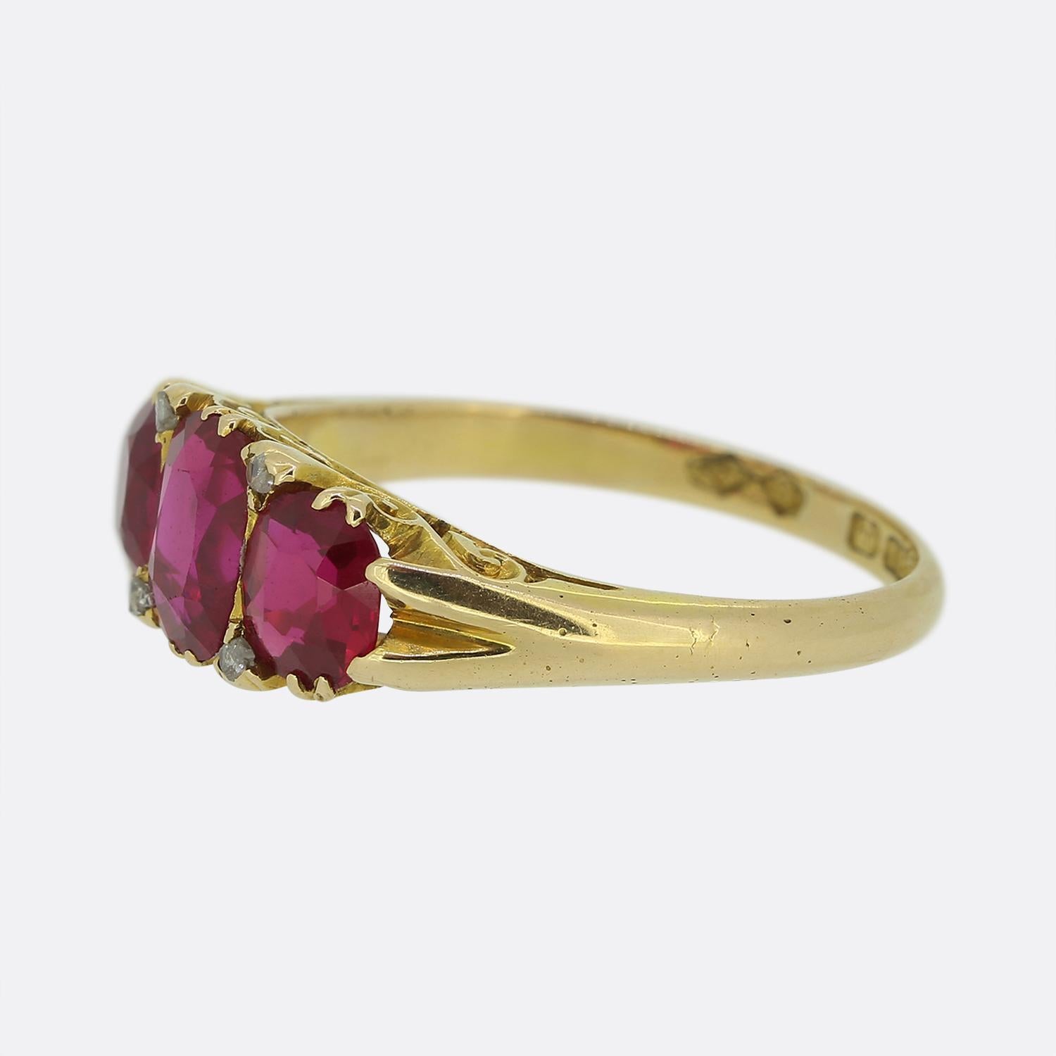 Here we have a lovely 18ct yellow gold Edwardian ruby three stone ring. The ring is exceptionally crafted and the three synthetic rubies have a rich vibrant red hue. The ring is finished with a patterned gallery and rose cut diamond