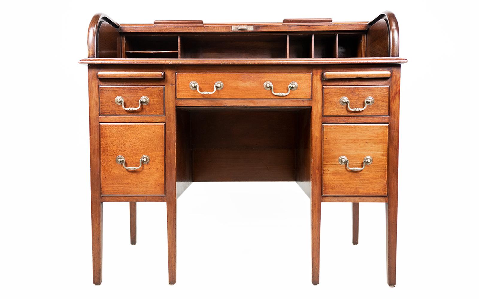 Tambour roll top desk

Early 20th-century Edwardian mahogany tambour roll top desk.

The tambour front opens to a compartmentalised interior over a central drawer, raised upon twin two drawer pedestals, each with swan-shaped pulls below