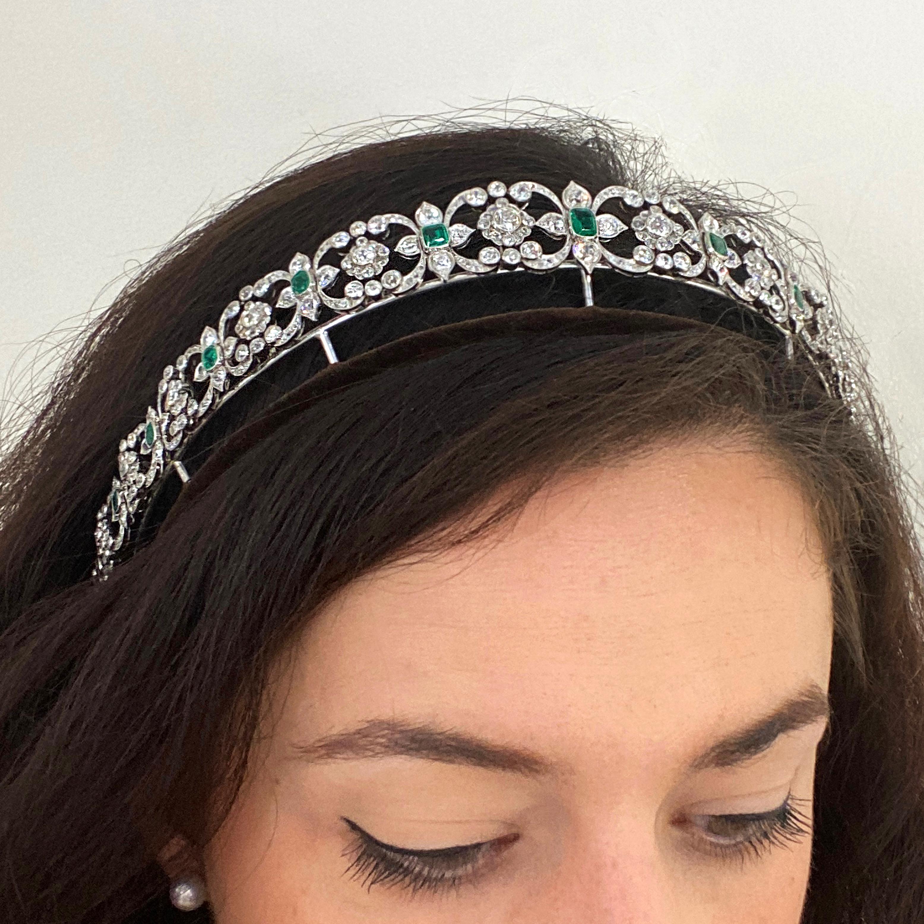 An Edwardian emerald and diamond tiara, choker and bracelet combination, of fine open work with a series of quatrefoils, each with an emerald-cut emerald in the centre and diamond set scrolls and a cluster, set with old-cut and rose-cut diamonds,