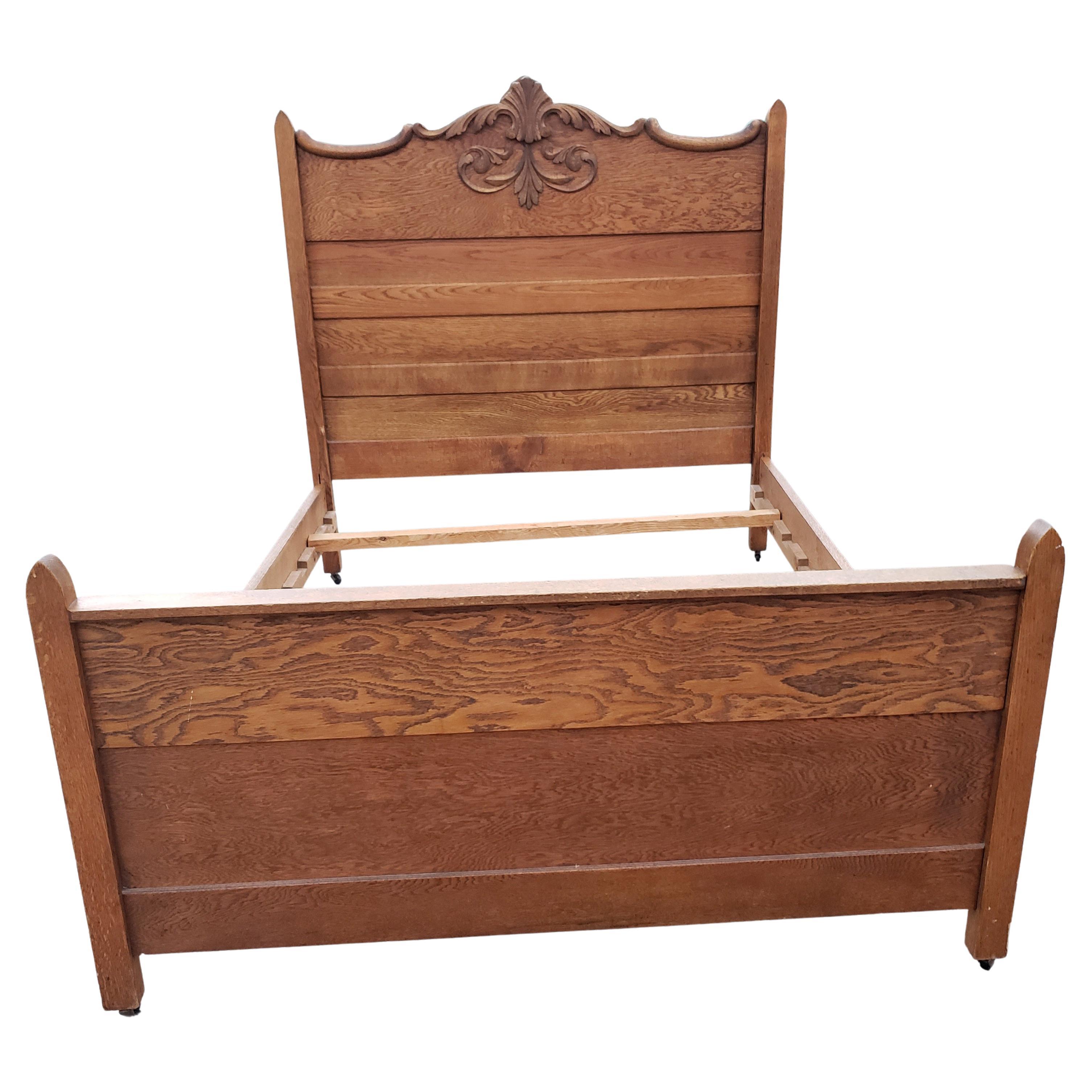 Edwardian Tiger Oak Full Size Bed on Wheels.
Very nice carvings. Original wheels. Very good vintage condition

Measures 56