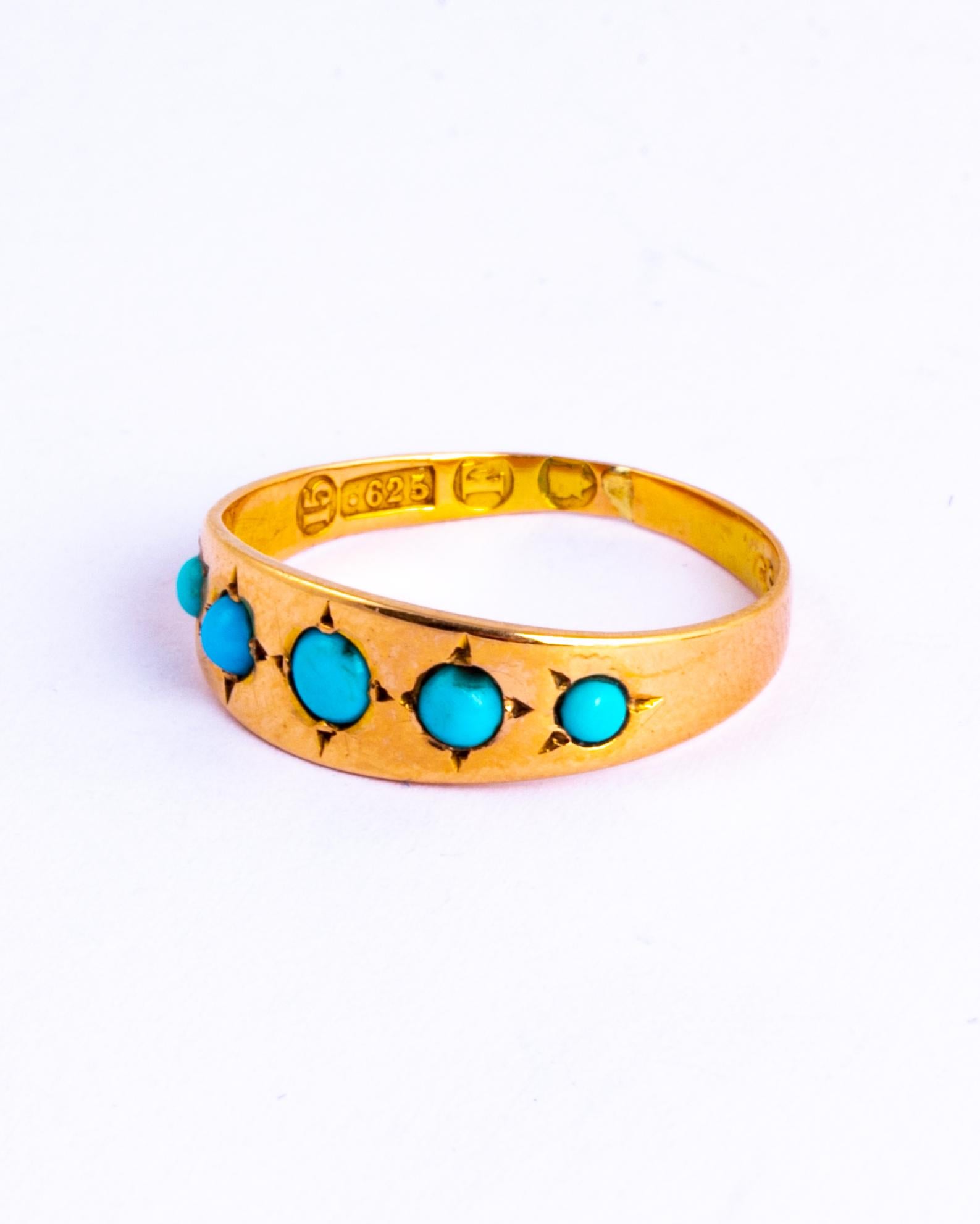 This glossy 15ct gold band holds five beautifully bright turquoise cabochon stones. The stones are slightly graduated in size as they get to the centre stone, starting smaller on the outside with the largest in the middle. made in London, England.
