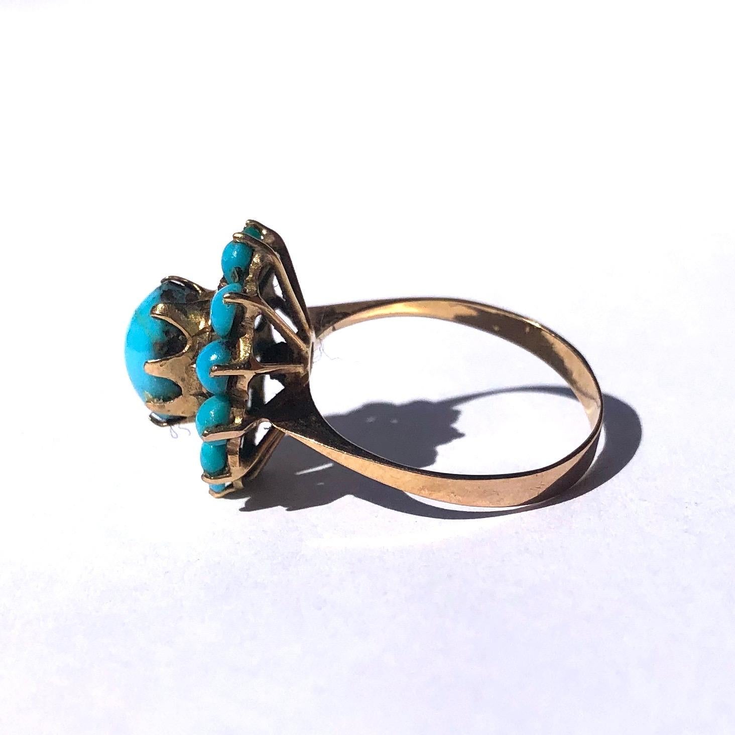 This bright turquoise is really complimented by the bright yellow 18ct gold. The central stone is held in a simple law setting which is then surrounded by a textured gold frame which smaller turquoise stones surrounding that. The underneath of the