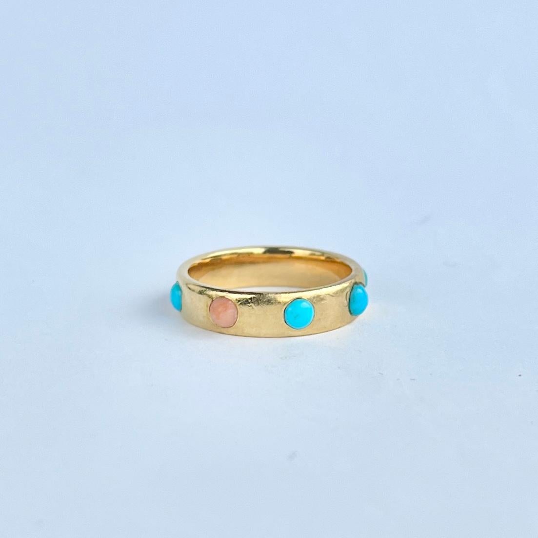 This glossy 18ct gold band holds a beautifully bright natural turquoise cabochon stones and coral. The stones are bright and beautiful and complimented by the yellow gold perfectly. 

Ring Size: M or 6 1/4 
Band Width: 4.5mm

Weight: 5.1g
