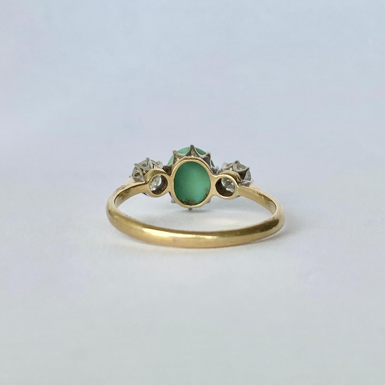 The central stone is a turquoise cabochon and either side it sit two old mine cut diamonds. The diamonds total approx 50pts. The stones are set in platinum and the ring is modelled in 18carat gold. 

Ring Size: O or 7 1/4 
Height Off Finger: