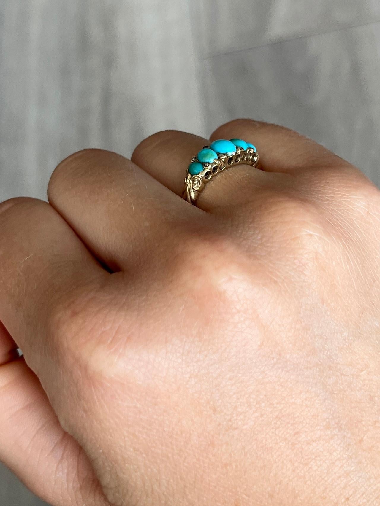 This wonderful turquoise five stone ring is modelled in 18ct gold and features eight small diamond points that sit between the oval turquoise stone cabochons. 

Ring Size: J 1/2 or 5

Weight: 6.5g