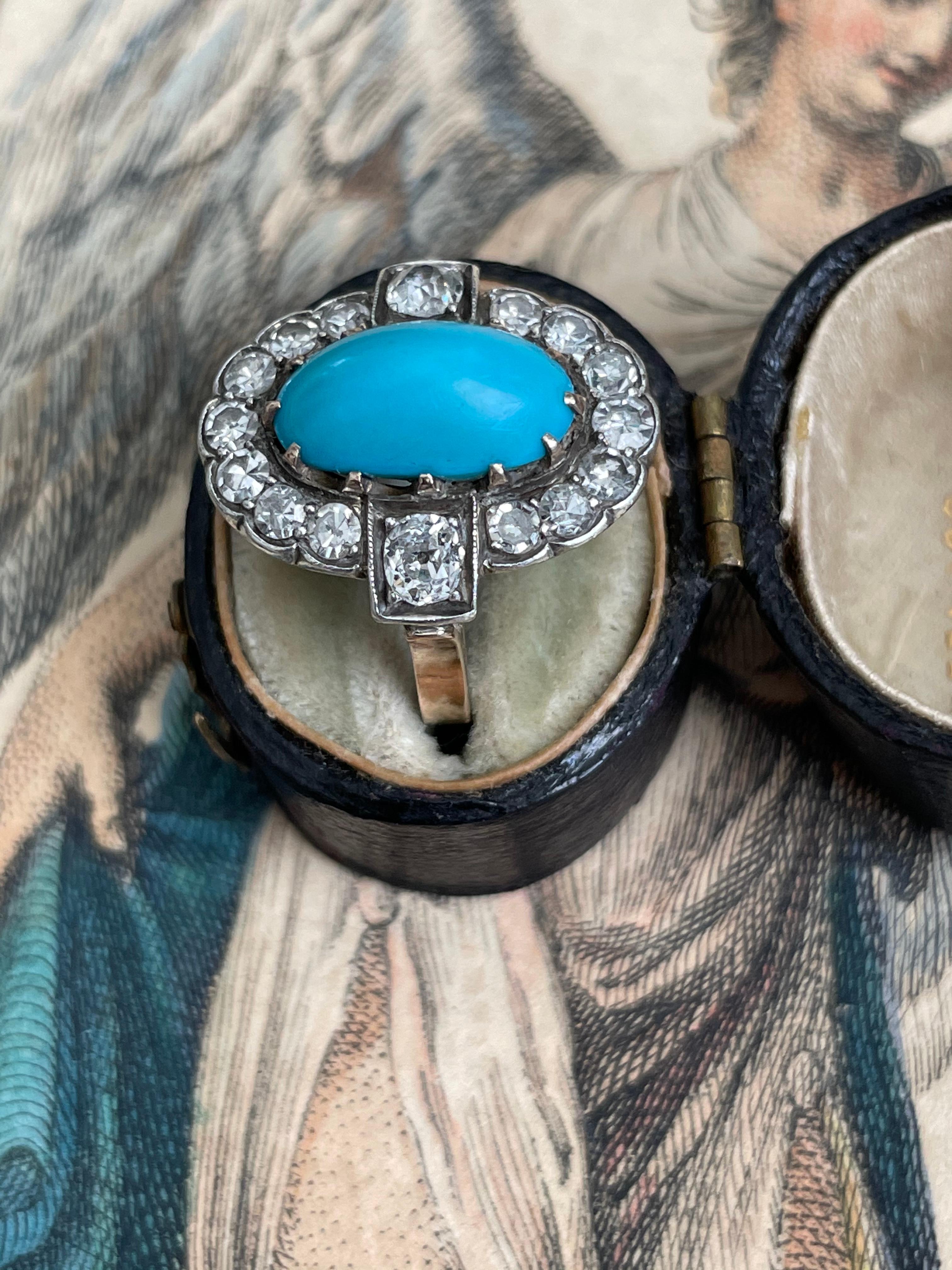 A bright robin’s egg blue turquoise cabochon is perfectly framed in halo of sparkling single-cut and old mine-cut diamonds. This Edwardian treasure is crafted in platinum topped 14k yellow gold. Currently a finger size 4.5. 

Measurements: 18.80 x