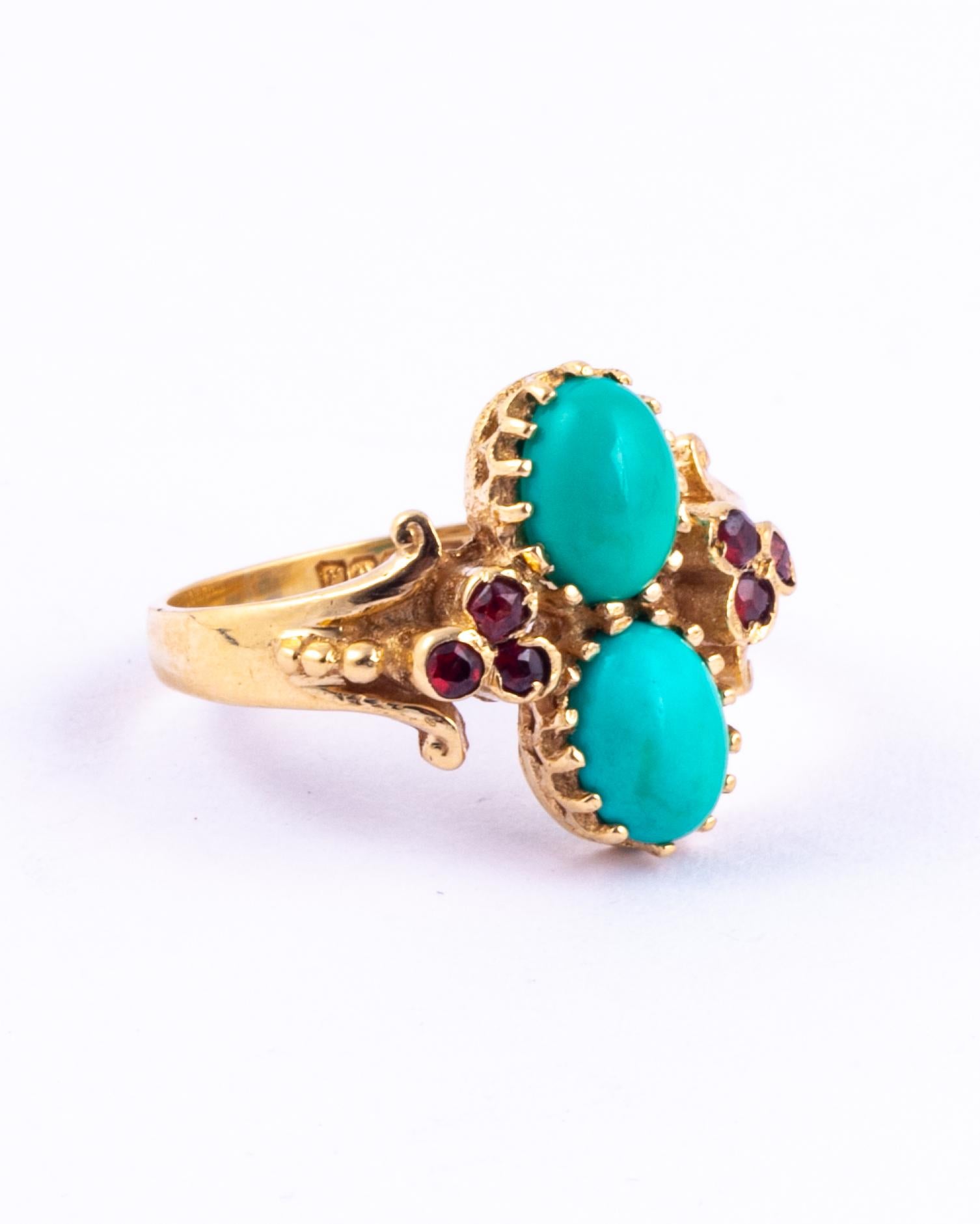 This gorgeous ring holds two bright cabochon turquoise stones and either side of these are trios of garnet. The glossy 9carat gold wraps around the stones and the shoulders have scroll and dot detail. Made in Birmingham, England. 

Ring Size: N or 6