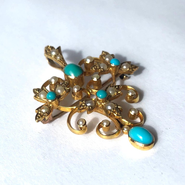 This gorgeous pendant/brooch holds five glossy turquoise stones and 19 sweet pearls. The design of the piece includes delicate scrolls and there is also a free hanging drop which holds a turquoise stone. 

Dimensions: 40x29mm

Weight: 5.4g