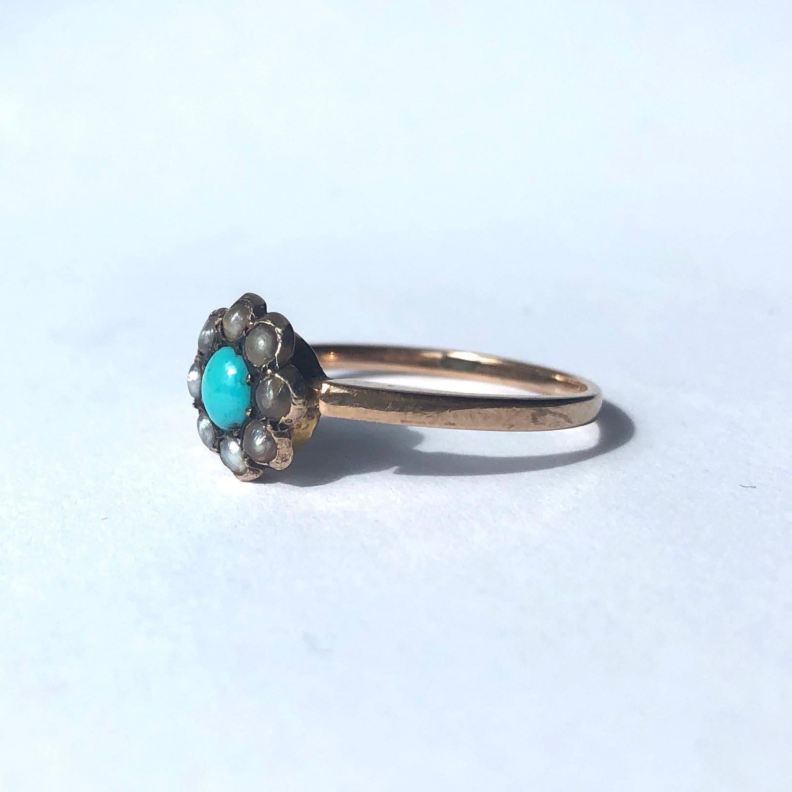 This sweet cluster ring holds a bright turquoise stone at the centre of a halo of glossy pearls. The setting and band is simple and modelled in 9ct gold. Made in Birmingham, England. 

Ring Size: O or 7 1/4
Cluster Diameter: 9mm

Weight: 1.6g