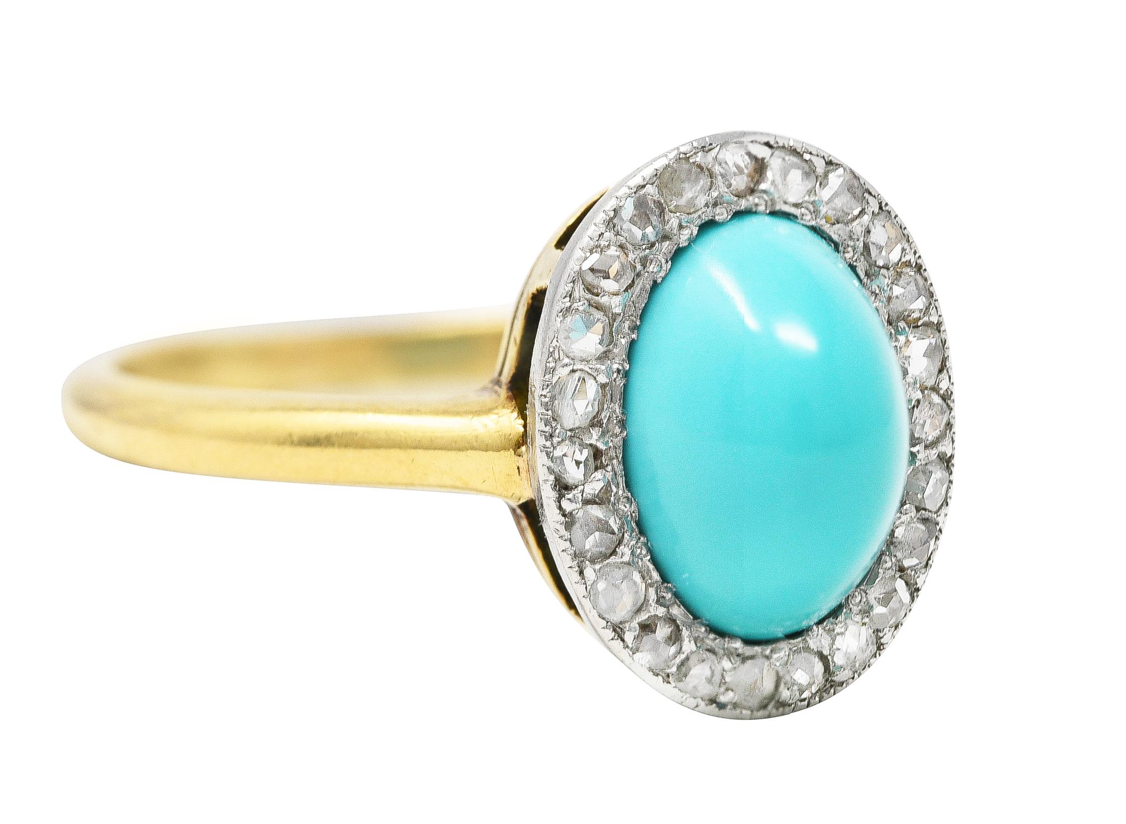 Centering an oval shaped turquoise bullet cabochon measuring 7.0 x 9.0 mm. Opaque and bright robin's egg blue in color - bezel set. Featuring a halo surround of rose cut diamonds. Bead set in platinum - weighing 0.12 carat total. Quality consistent