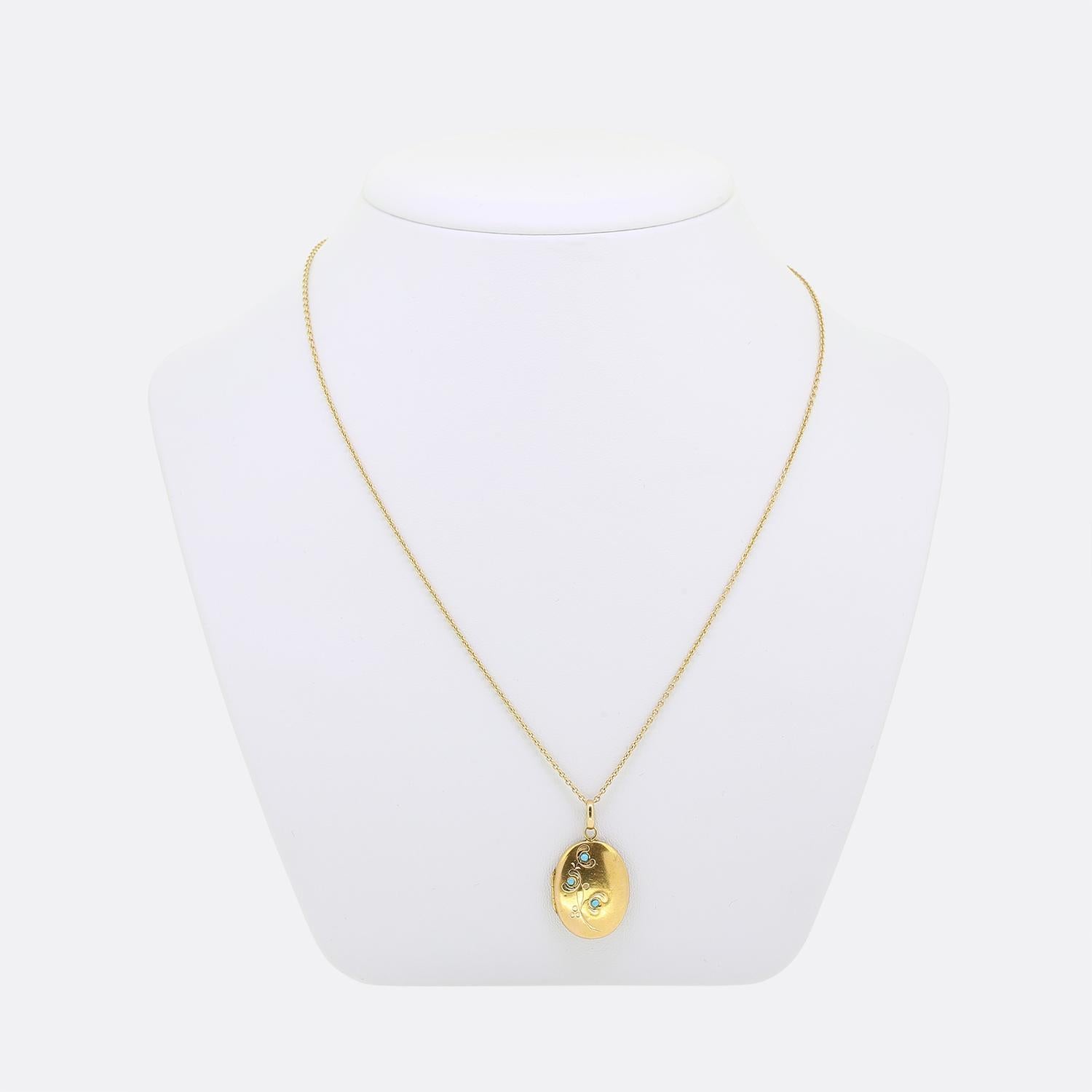 Here we have a lovely locket necklace. This antique locket has been crafted from 18ct yellow gold into an oval shape and expertly engraved with a curvaceous floral design whilst being set with a trio of round shaped turquoise. The reverse side