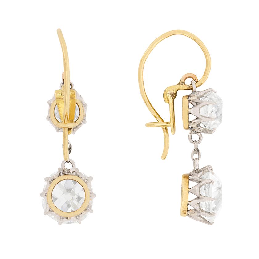 These stunning earrings have been handmade and date to Edwardian era. They are two stone drop earrings, with the larger stone on each earring weighing 1.25 carat each. The diamonds at the top of the drop each weigh 0.60 carat and all the diamonds