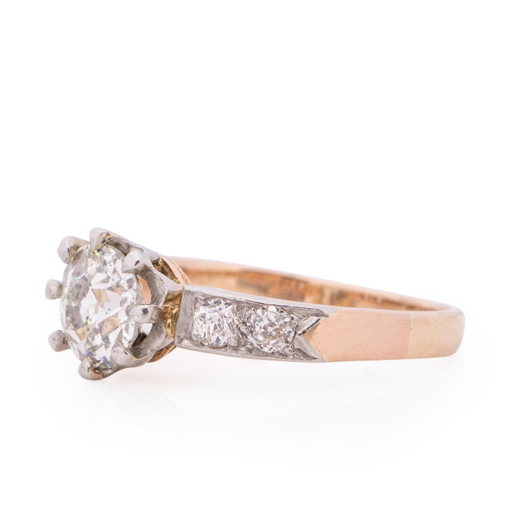 Here we have a two tone beauty. This classic Edwardian solitaire ring has a breath taking 1.25Ct old European cut diamond being held by 14K white gold, accenting the center gem are two old euros on either side also set in white gold. Bringing the