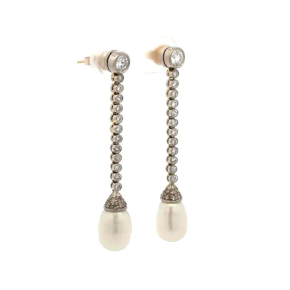 Simply Beautiful! Finely detailed Edwardian Vintage Diamond and Pearl Platinum Drop Earrings. Hand set with 0.75tcw Diamonds and Pearls. Exquisitely Hand crafted in Platinum and 14K White Gold. Measuring approx. 1.7” long. More Beautiful in Real