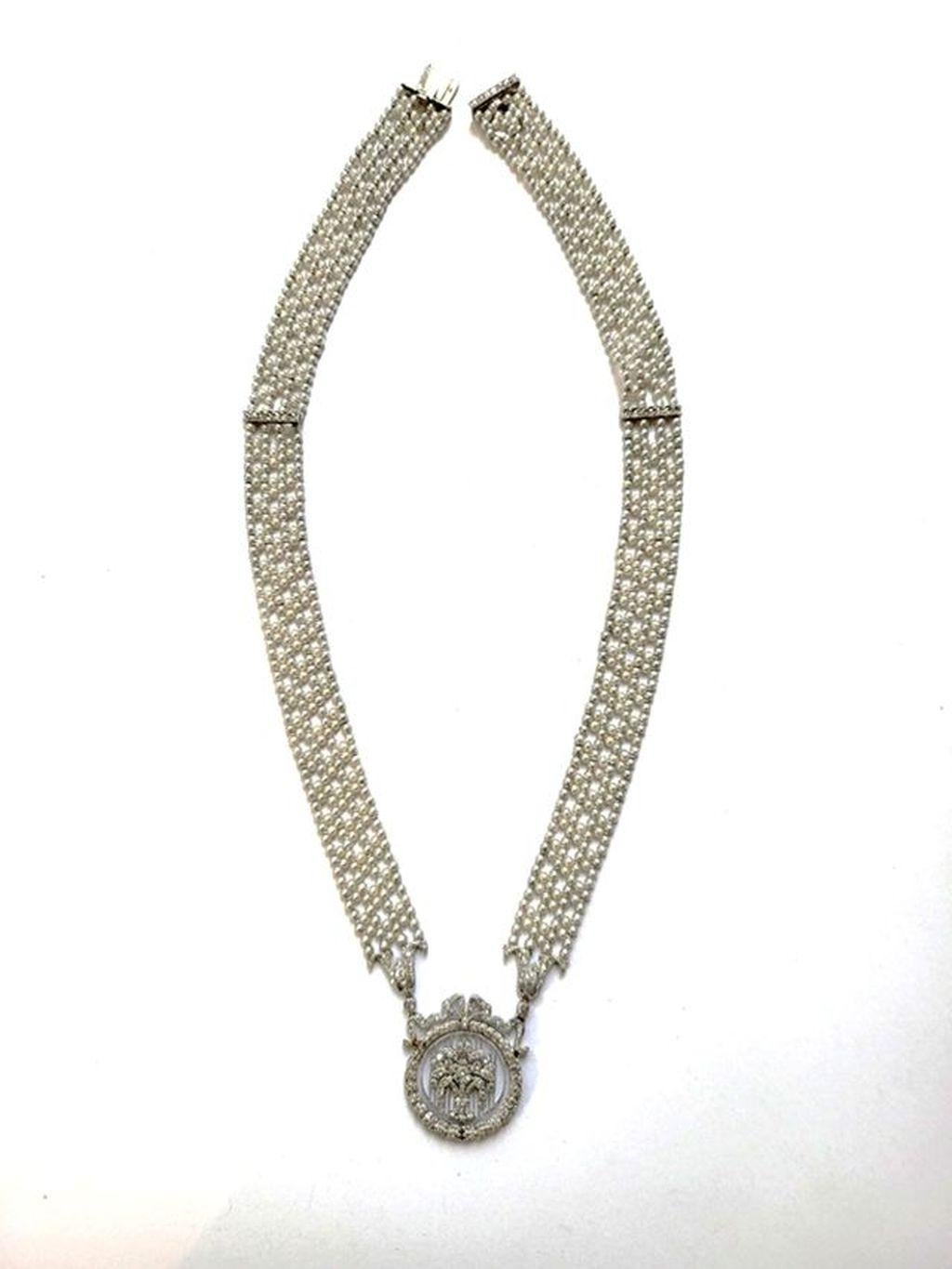 An exquisite creation of jewelry making!
This Edwardian neckless is composed of rose cut diamonds set in platinum and lustrous seed pearls arranged in a refined pattern. 
The beautiful lattice work of the diamond pendant in form of a flower basket