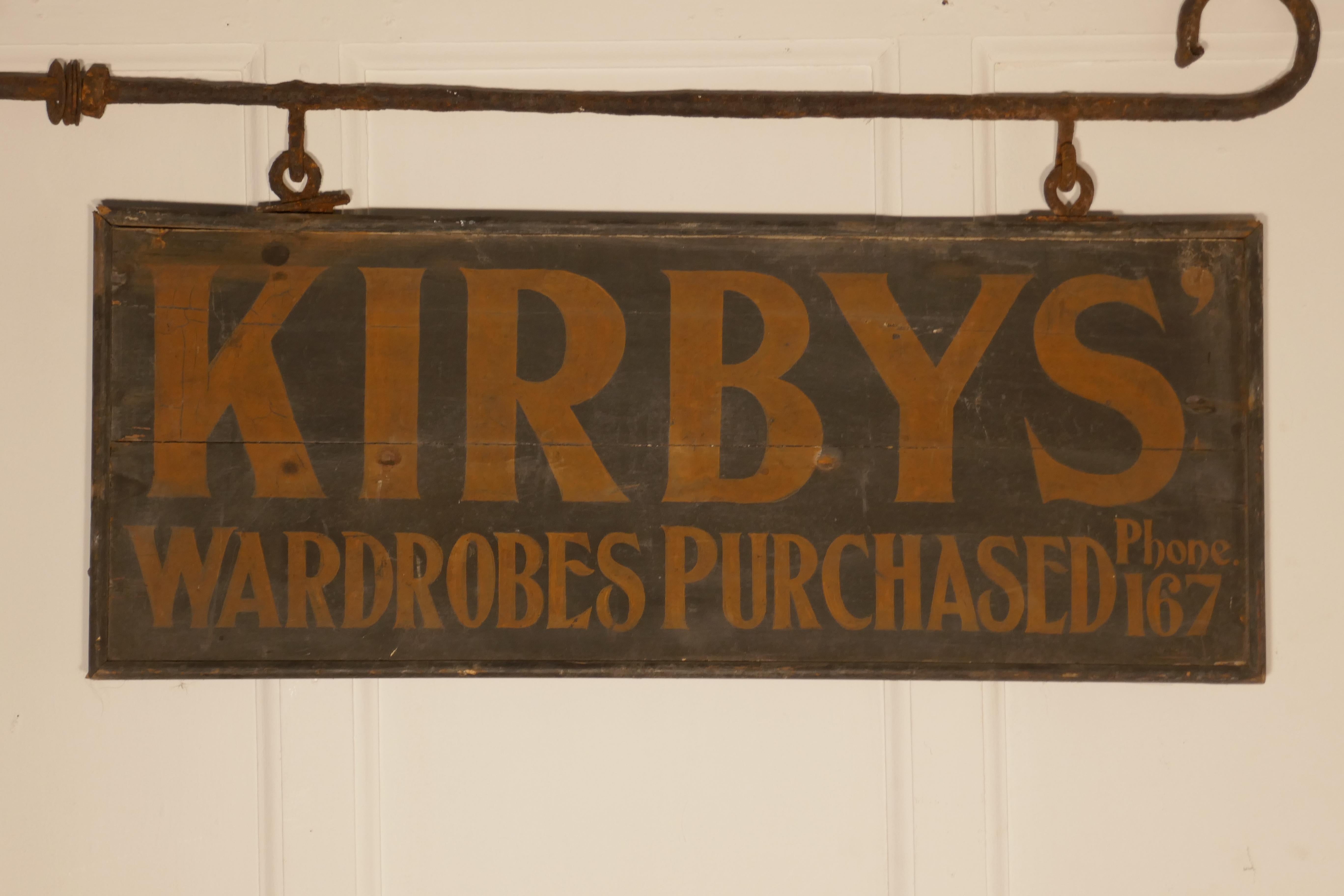 Edwardian wall hung shop sign, Kirbys’ wardrobes purchased

A great piece of social history, this is a wooden sign painted on both sides and hanging on a blacksmith made Iron bracket, still in use in the 1930s when the phone number was squeezed in