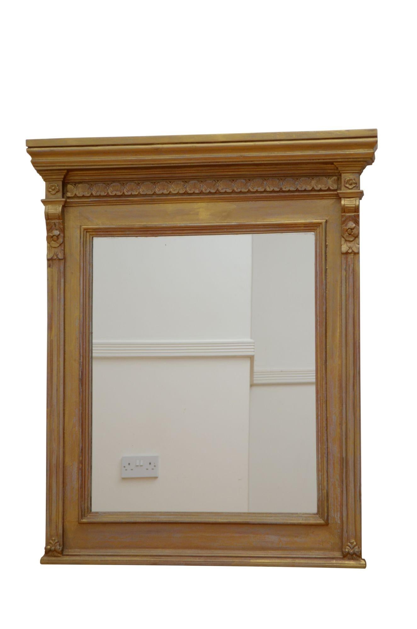 K0620 Elegant Edwardian wall mirror, having cavetto cornice above carved frieze and oblong glass, (possibly a replacement) flanked by reeded pilasters with drop carvings. This antique mirror has been refinished in the past and it is in home ready