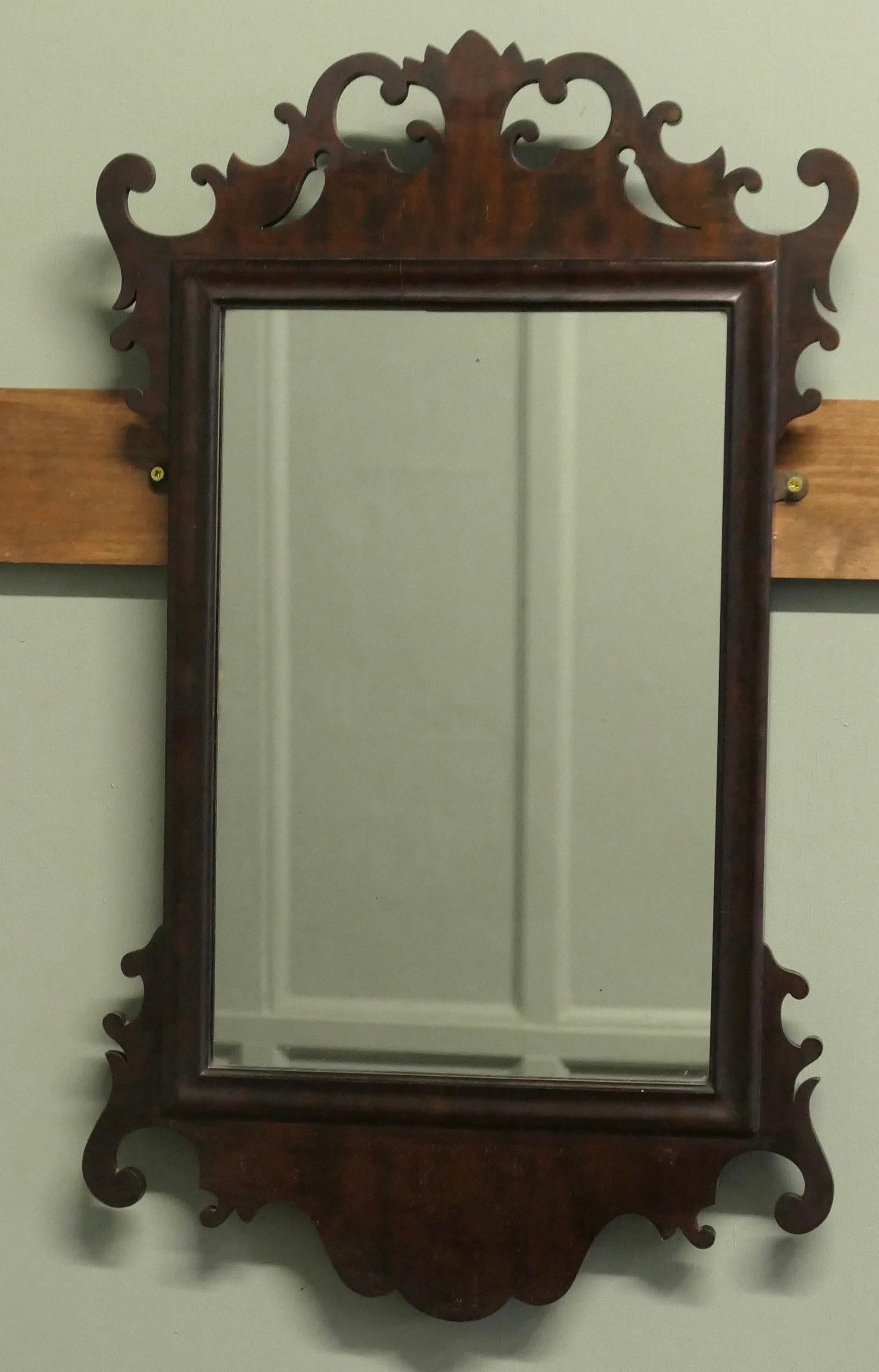 Edwardian Walnut Wall Mirror
 
Charming walnut wall mirror
This is a very attractive piece, it is carved with curls and swirls. The wood is all hand cut and is in remarkably good condition.
The Mirror frame is 36” tall and 21”wide 
TST166
