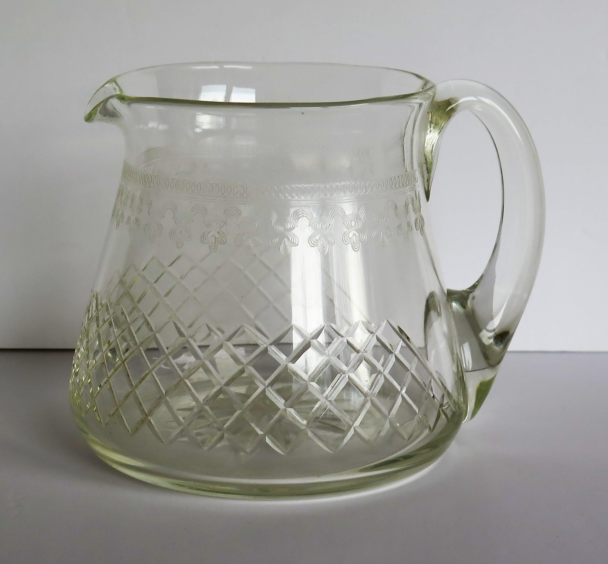 This is a good quality crystal lead glass, Water jug or pitcher which we date to the Edwardian period, circa 1900

This jug weighs about 600gm. unpacked and holds 1.5 pints. 

The jug or pitcher has a circular tapered shape with a good plain