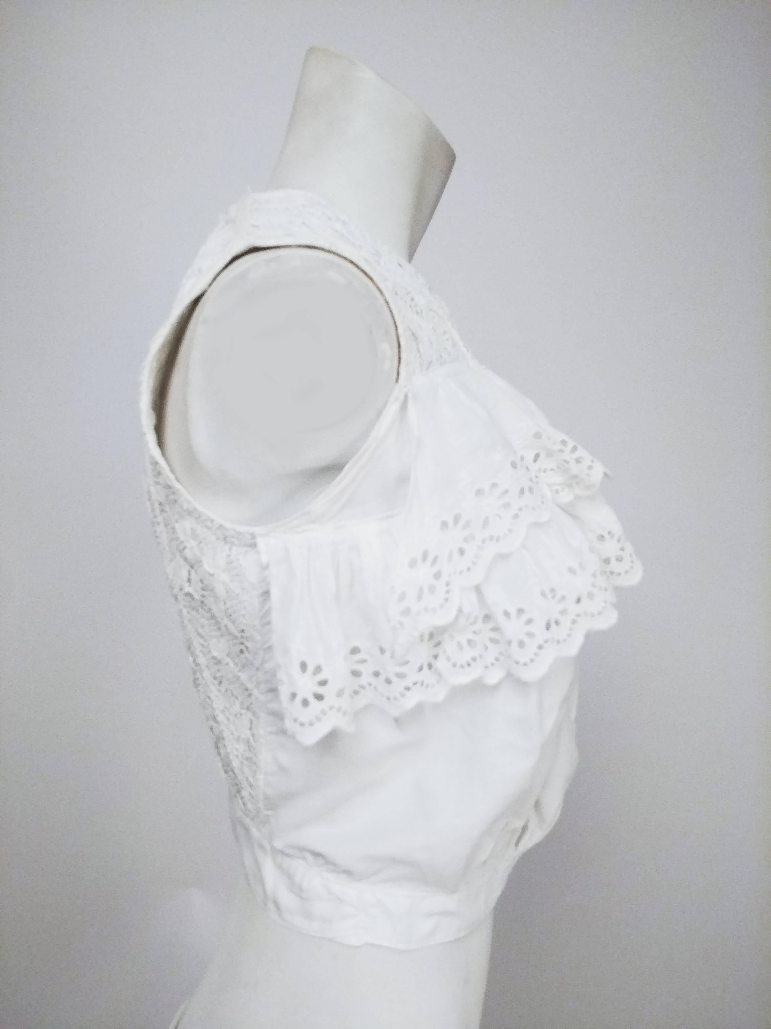 Edwardian White Eyelet Lace Ruffled Top. White cropped under-blouse garment ruffled eyelet lace at bust. Buttons down front. Lace-covered back. Quilted lining. 