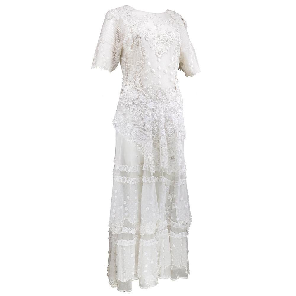 Beautifully pieced together Edwardian full-length dress made with antique laces and other embellished textiles. Zipper added in back.  Attached peplum with full length skirt. Sheer and unlined. Wonderful piece for a bride. Small pinholes and