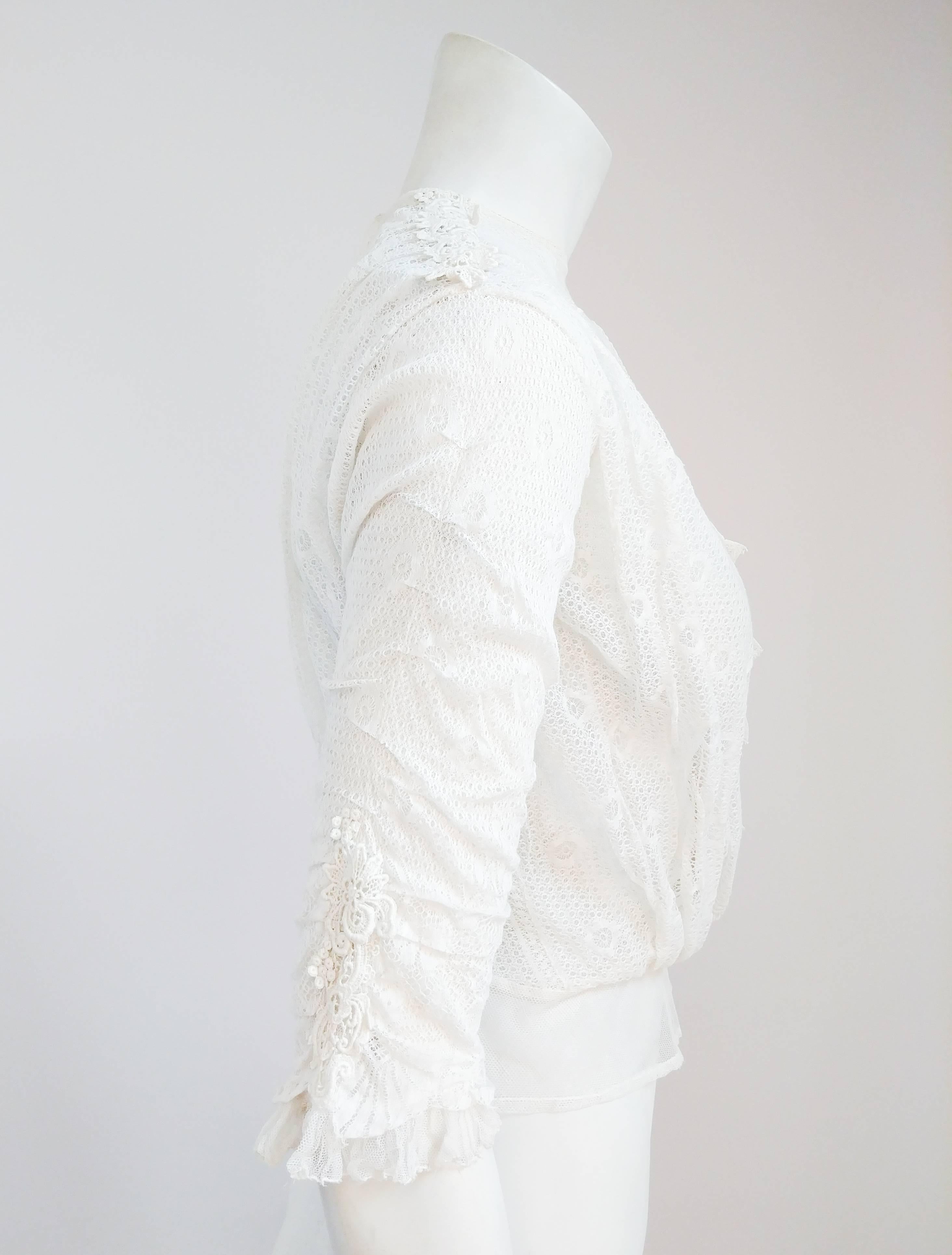 Edwardian White Lace Blouse. White lace blouse with mesh lining and neckline. Faux button up front and ruched sleeves with lace applique accents. Buttons up the back.